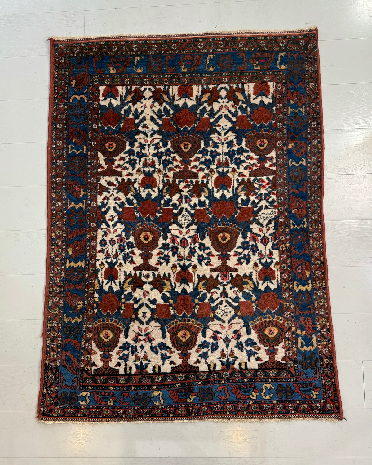 Full Afshar rug showing intricate floral pattern with deep blue and ivory tonesof antique Persian Afshar rug with traditional tribal design
