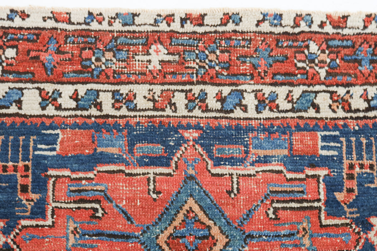 Close-up of the woven border and geometric motifs of an antique Persian rug