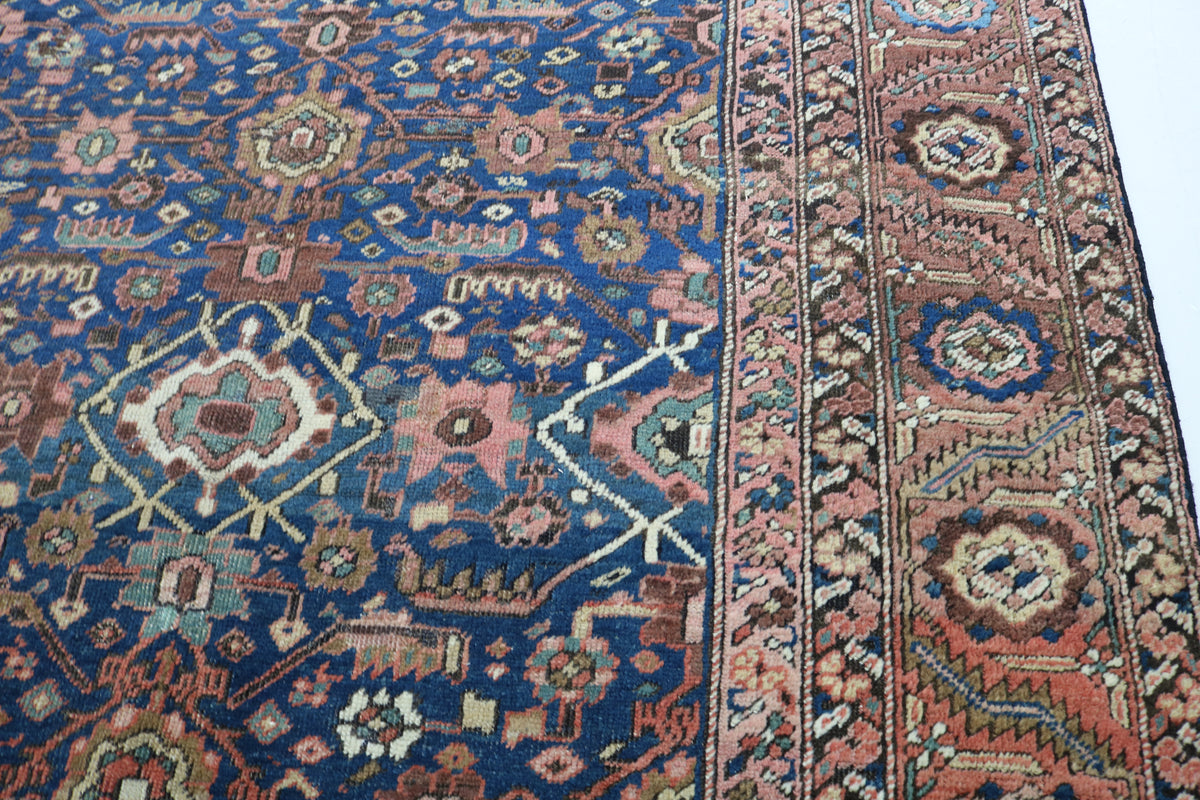 Close-up of antique carpet showing intricate blue field and border motifs