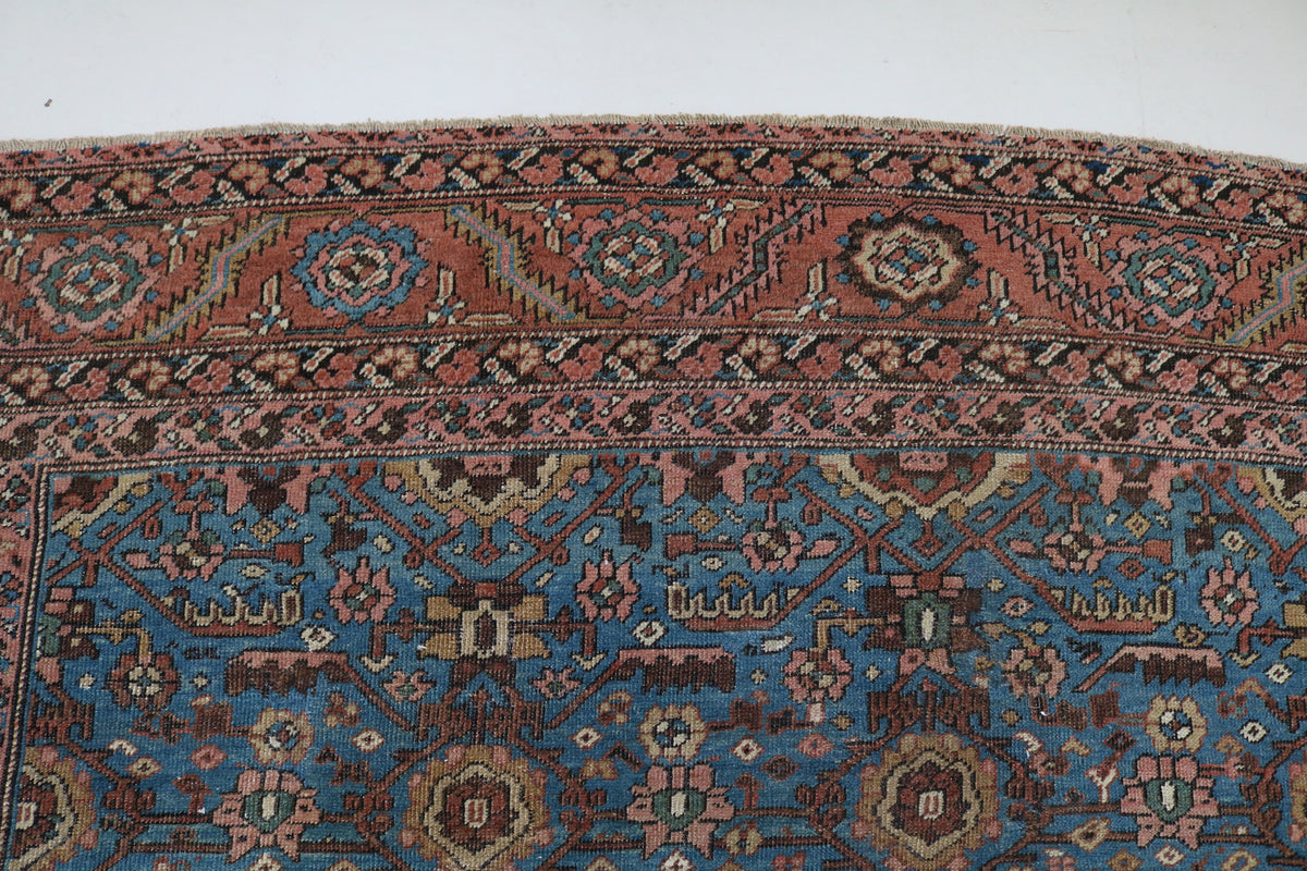 Detailed carpet section showing repeating motifs across the blue field