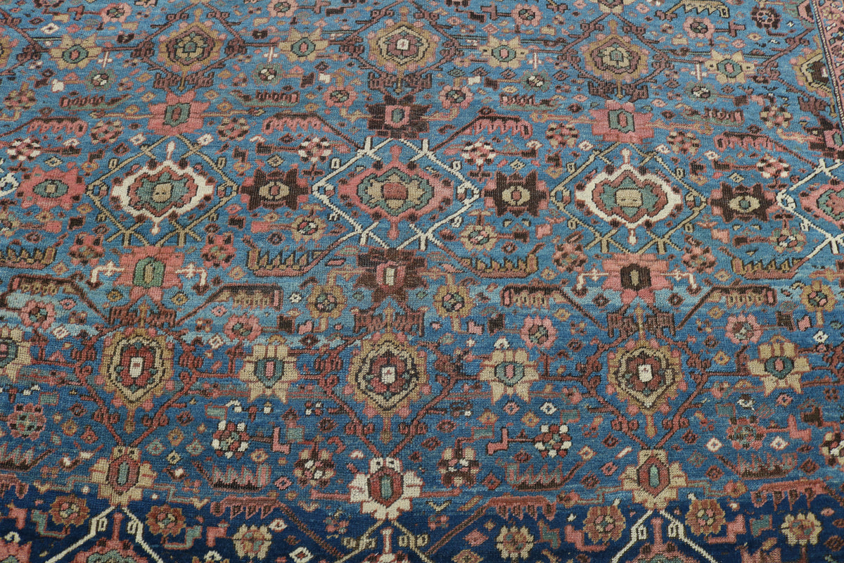 Close-up showing repeating floral motifs in blue, rust and earthy tones