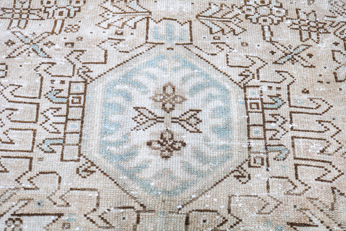 Close-up of Heriz-Karaja carpet field featuring delicate geometric motifs and faded blue