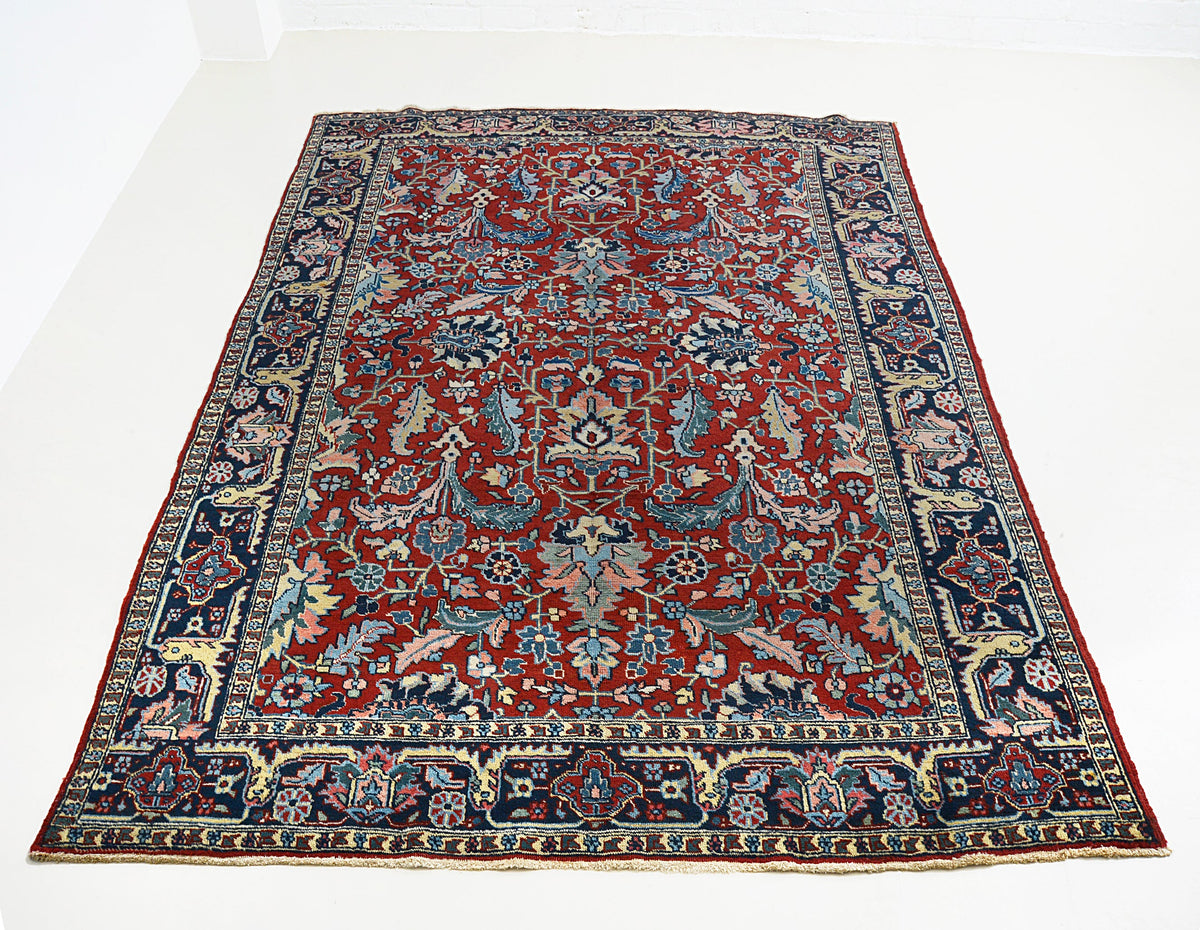 Full view of antique Persian Heriz carpet with richly detailed all-over floral design