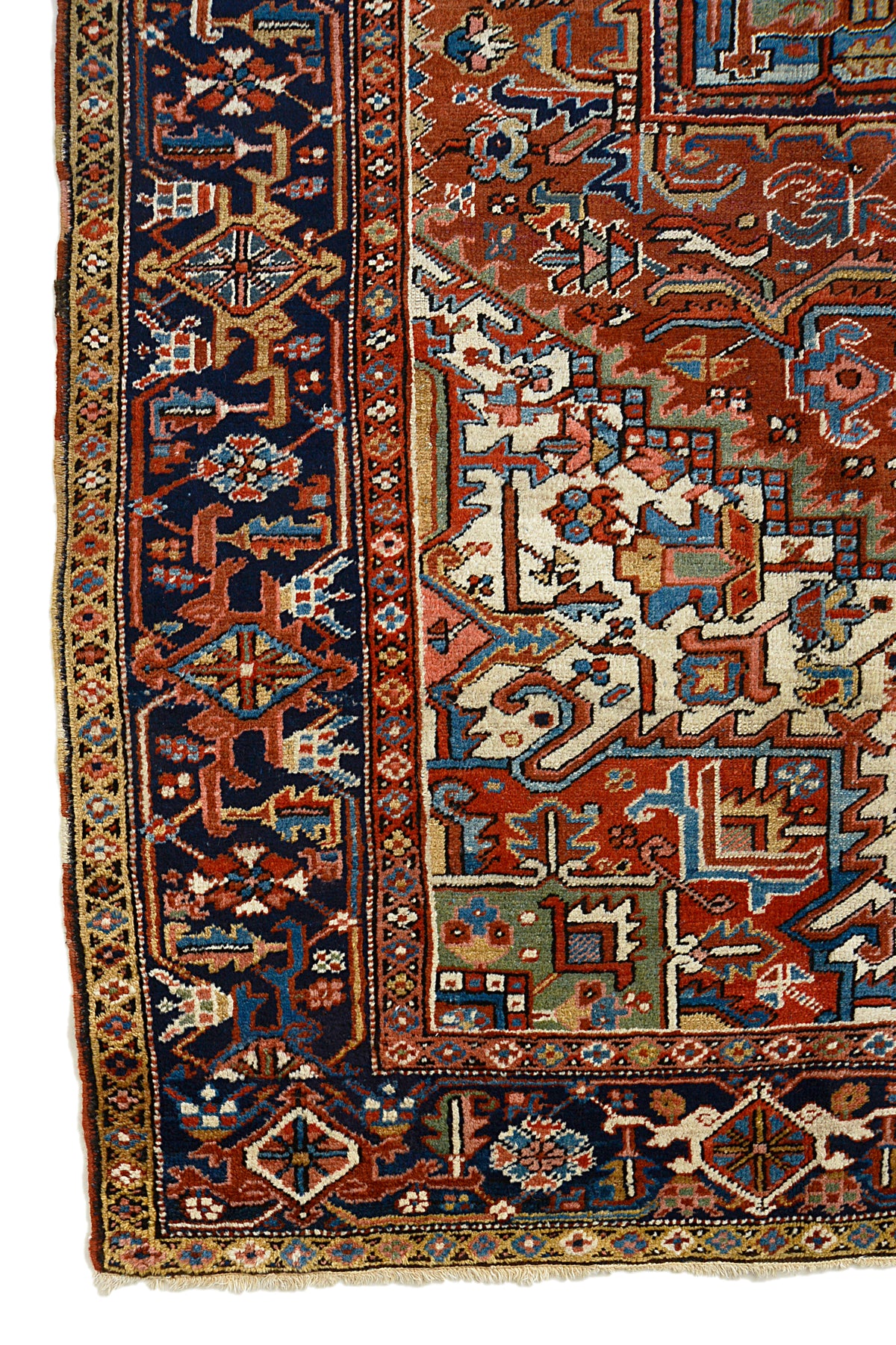 Antique Persian Heriz carpet with terracotta field, bold geometric medallion and deep indigo border