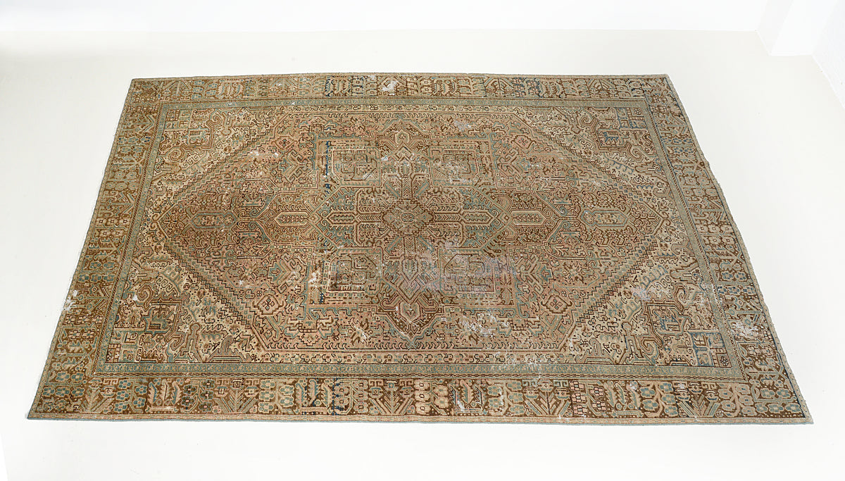 Full view of Persian Heriz carpet showing balanced geometric pattern and softly aged colours
