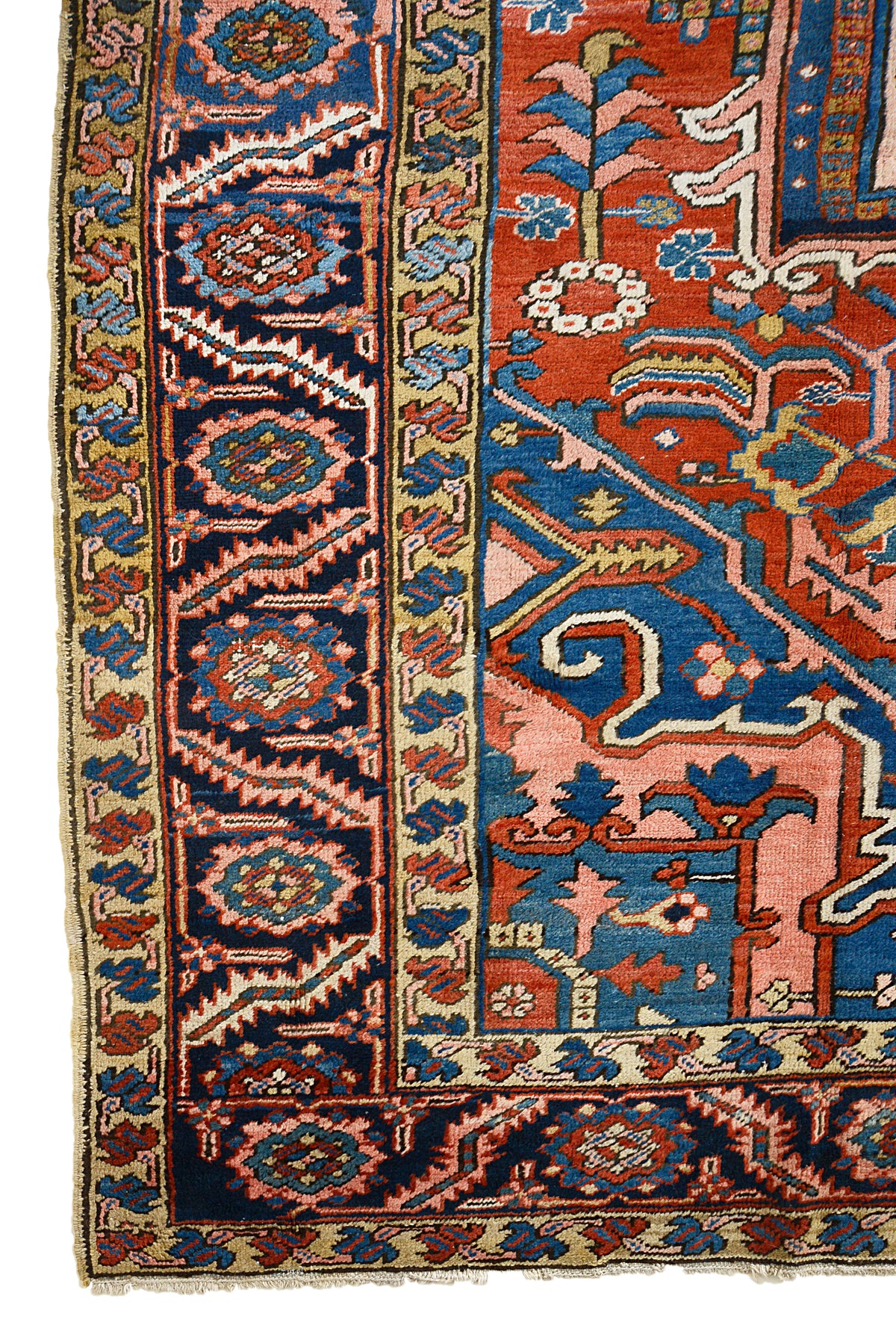 Antique Persian Heriz carpet with vibrant terracotta field, blue geometric motifs and ornate border
