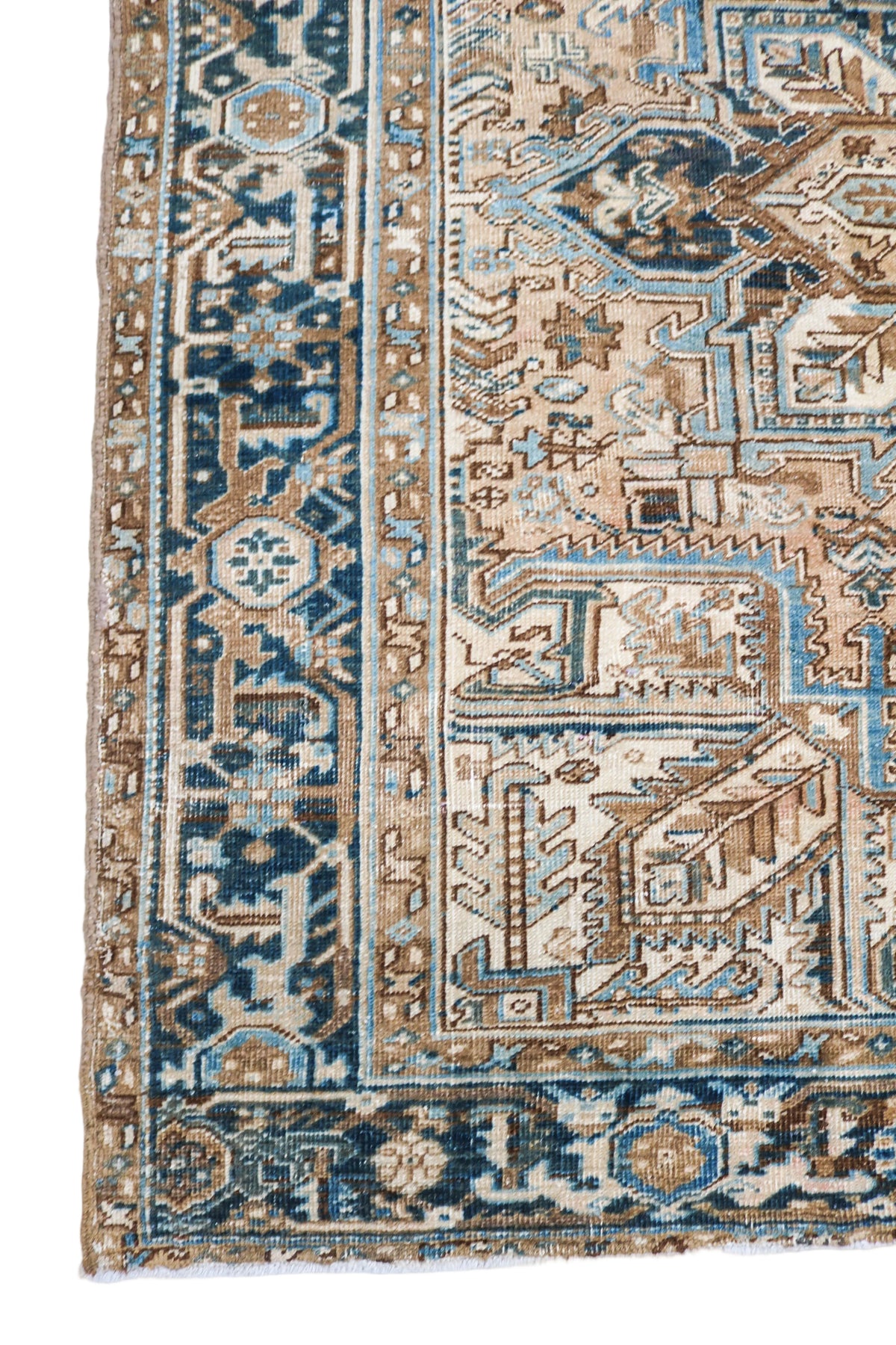 Antique Persian Heriz rug with geometric medallion, beige field and blue decorative borders