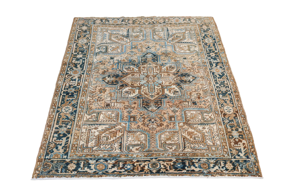Full view of antique Persian Heriz rug with bold geometric medallion design