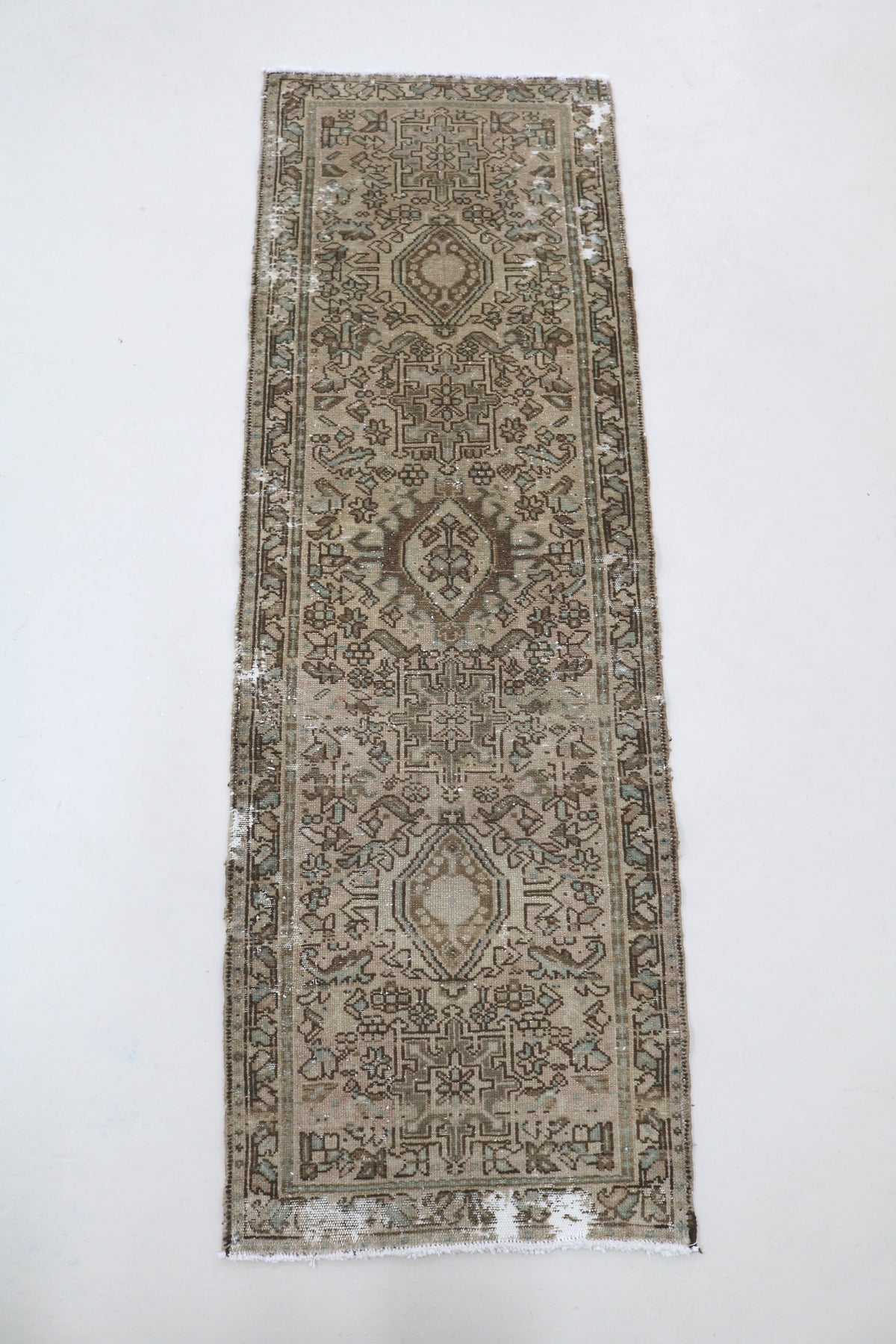 Full Heriz runner showing a narrow elongated design with repeating geometric patterns