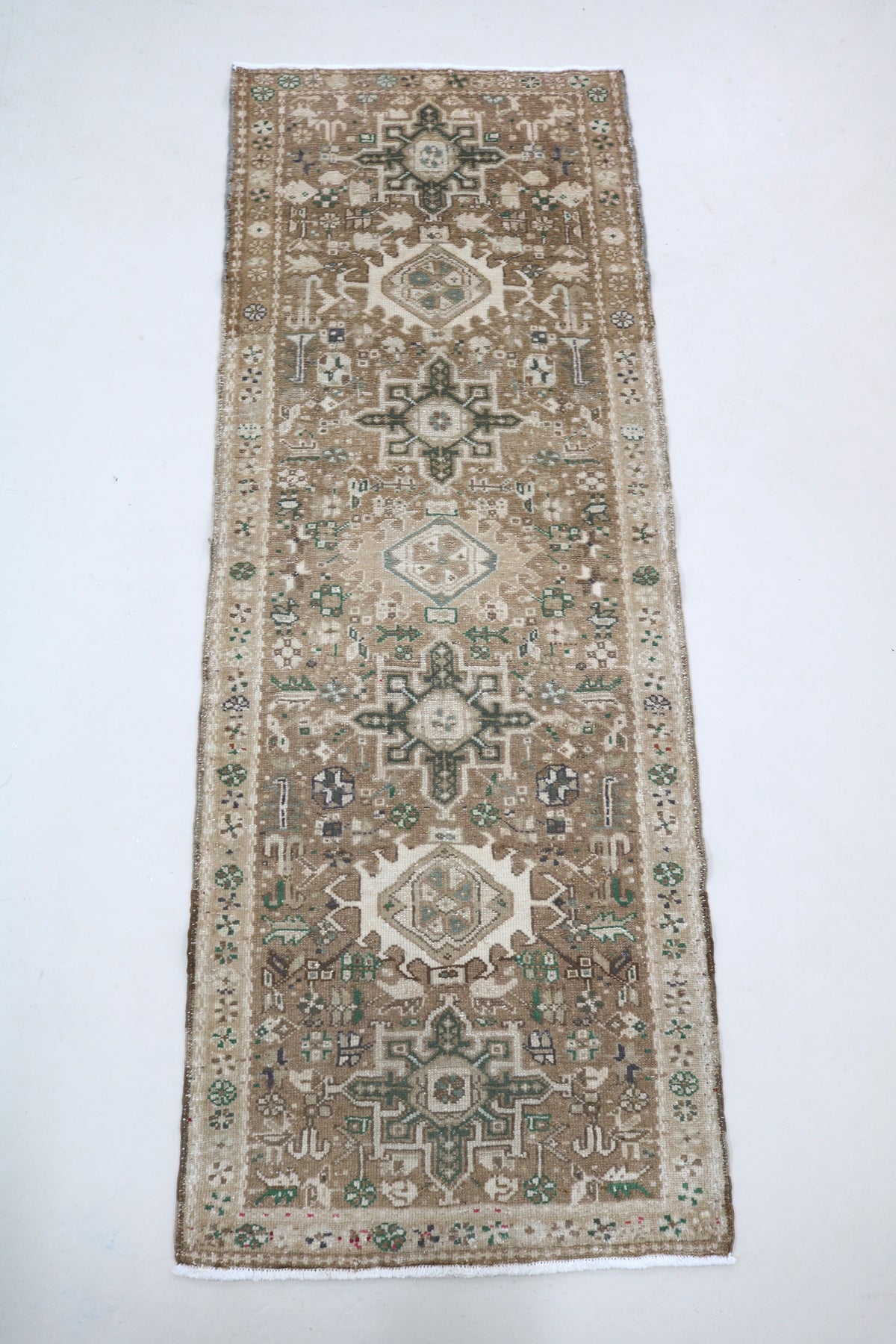 Full Heriz runner showing elongated design with repeating geometric medallions