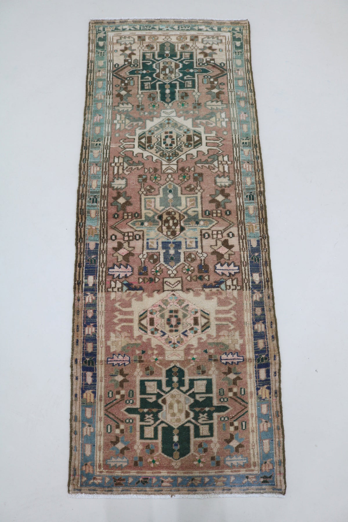 Full Heriz runner showing elongated design with repeating geometric medallions