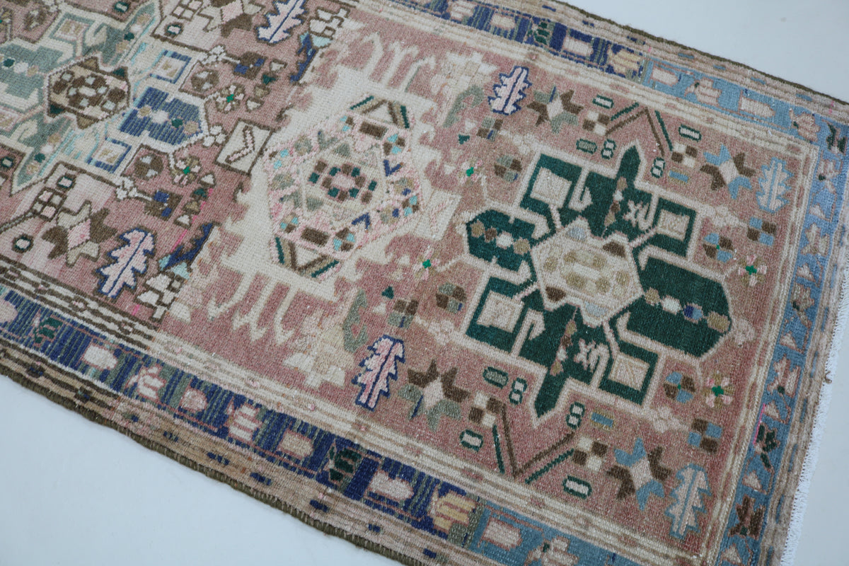 Detailed runner section showing central geometric medallions in soft muted tones