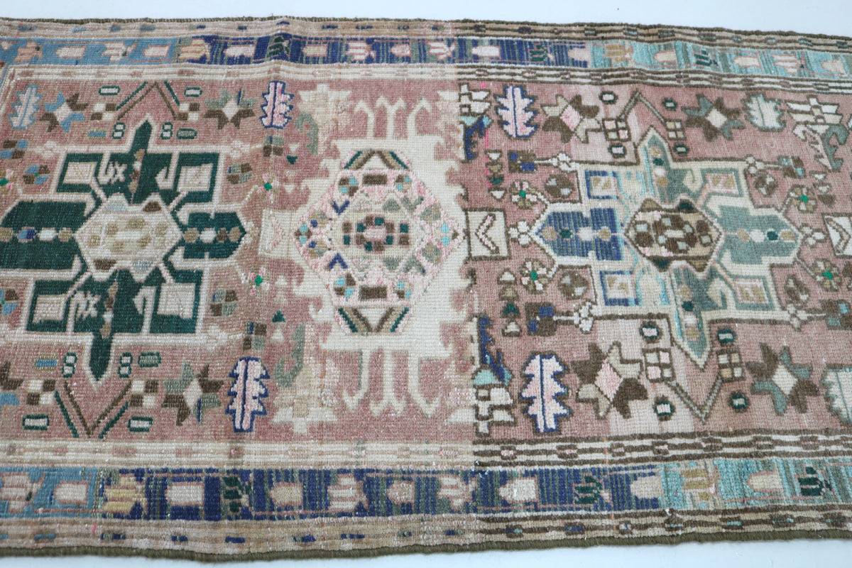 Full rug section featuring repeating medallions and a contrasting blue border