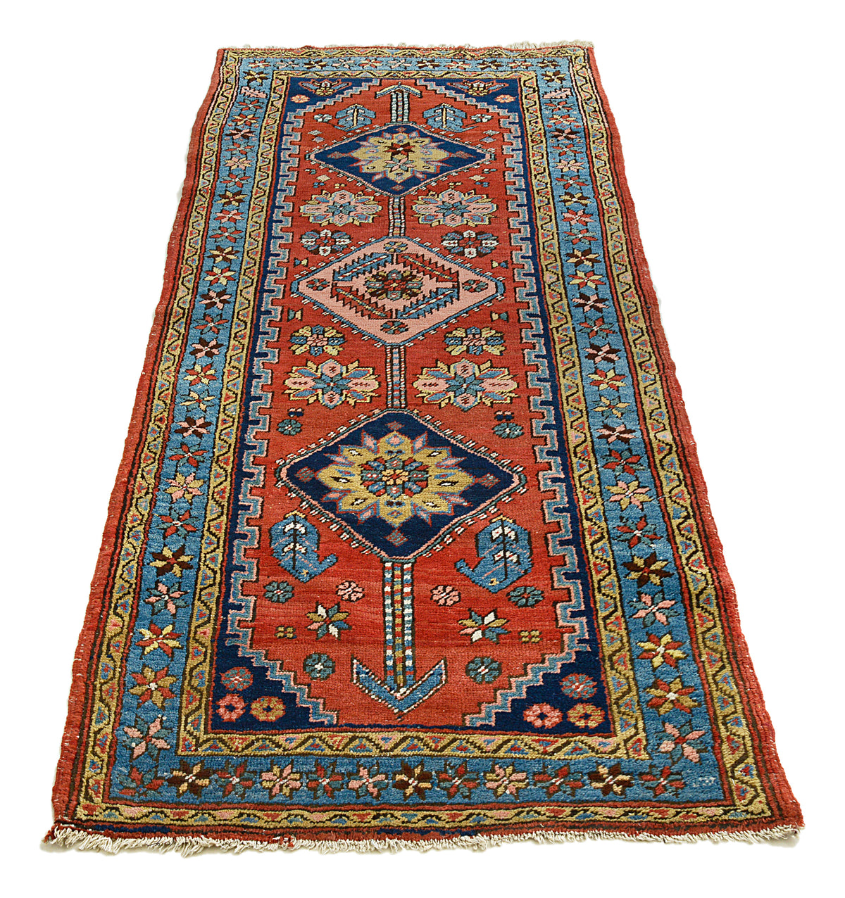 Full view of antique Heriz runner with geometric design in terracotta, blue and ivory