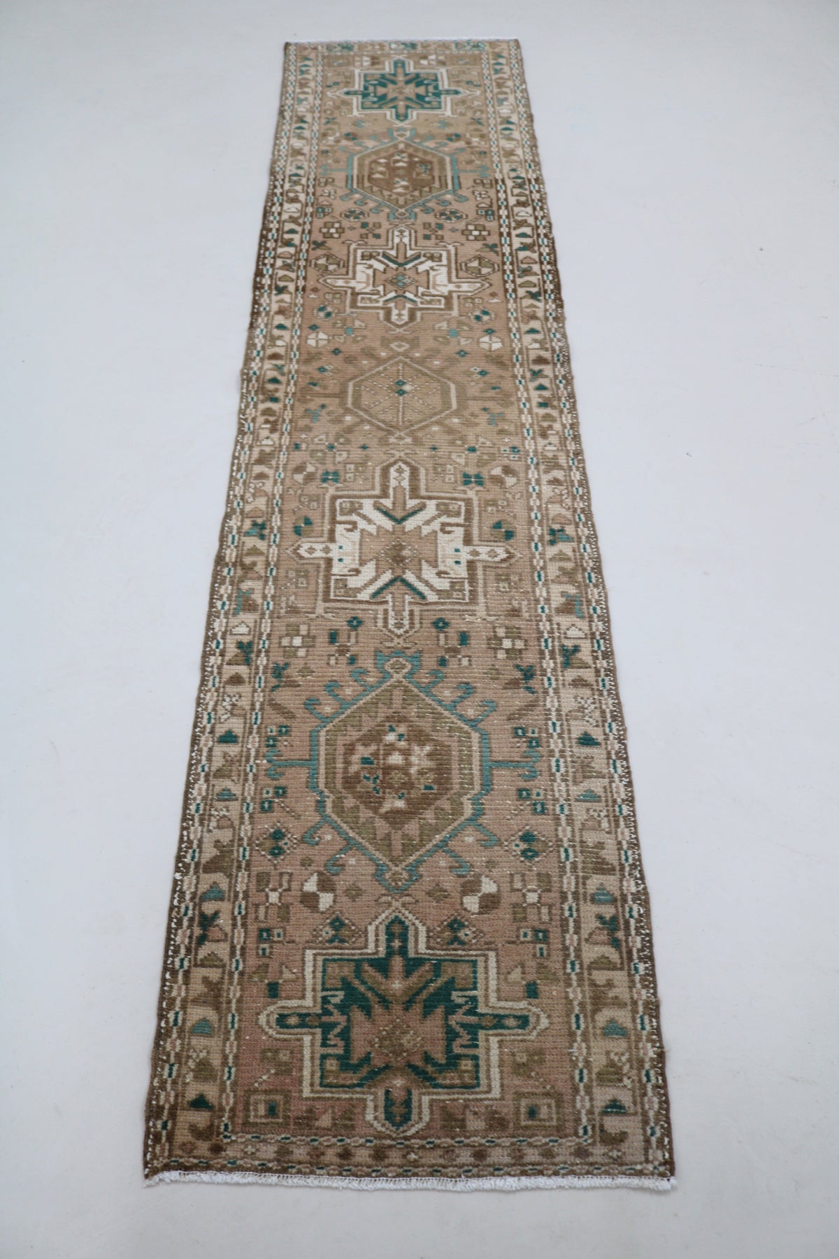 Full Heriz runner showing elongated design with repeating geometric medallions
