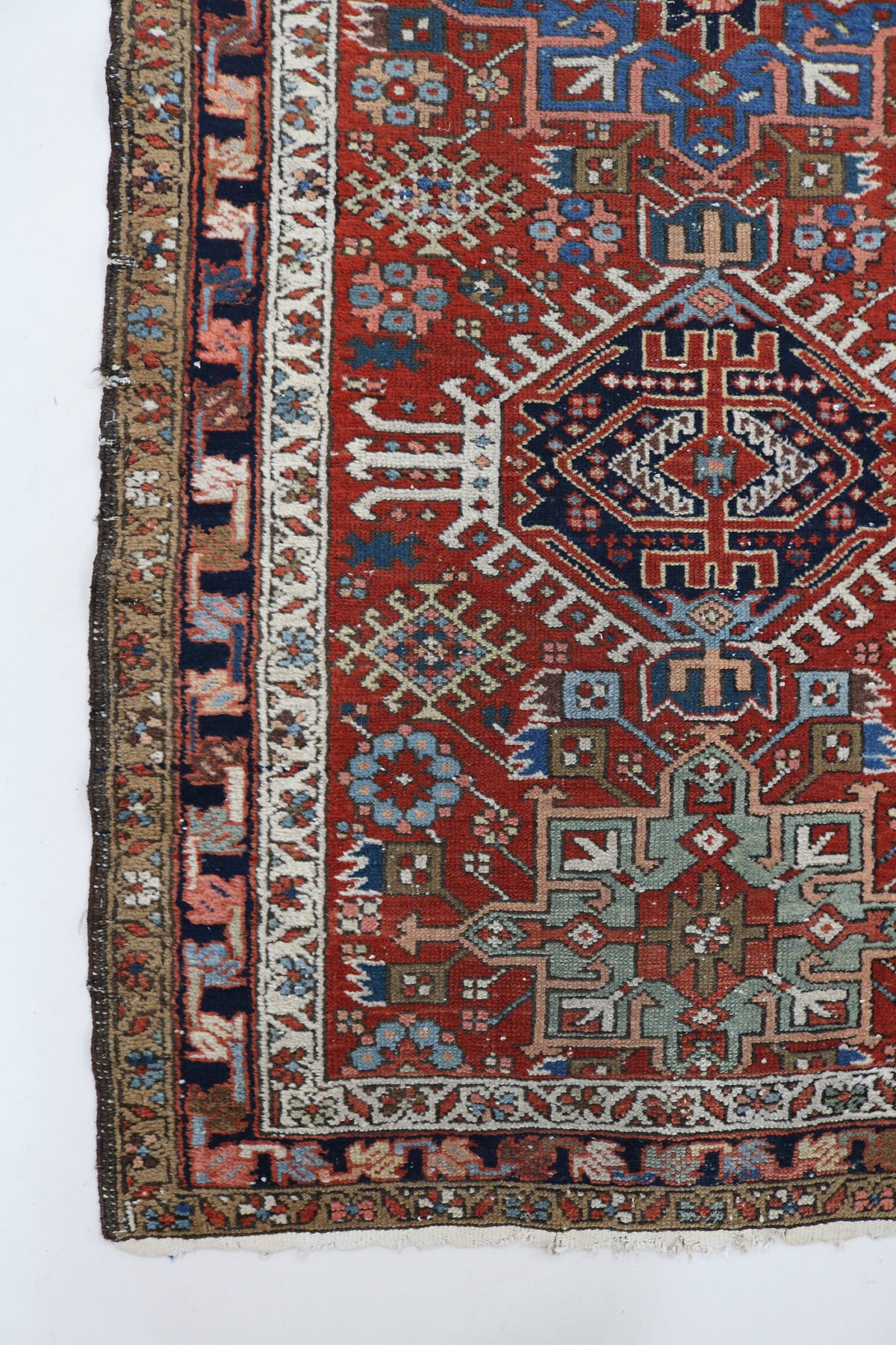 Antique Persian Karaja runner with rust red field and geometric medallion motifs