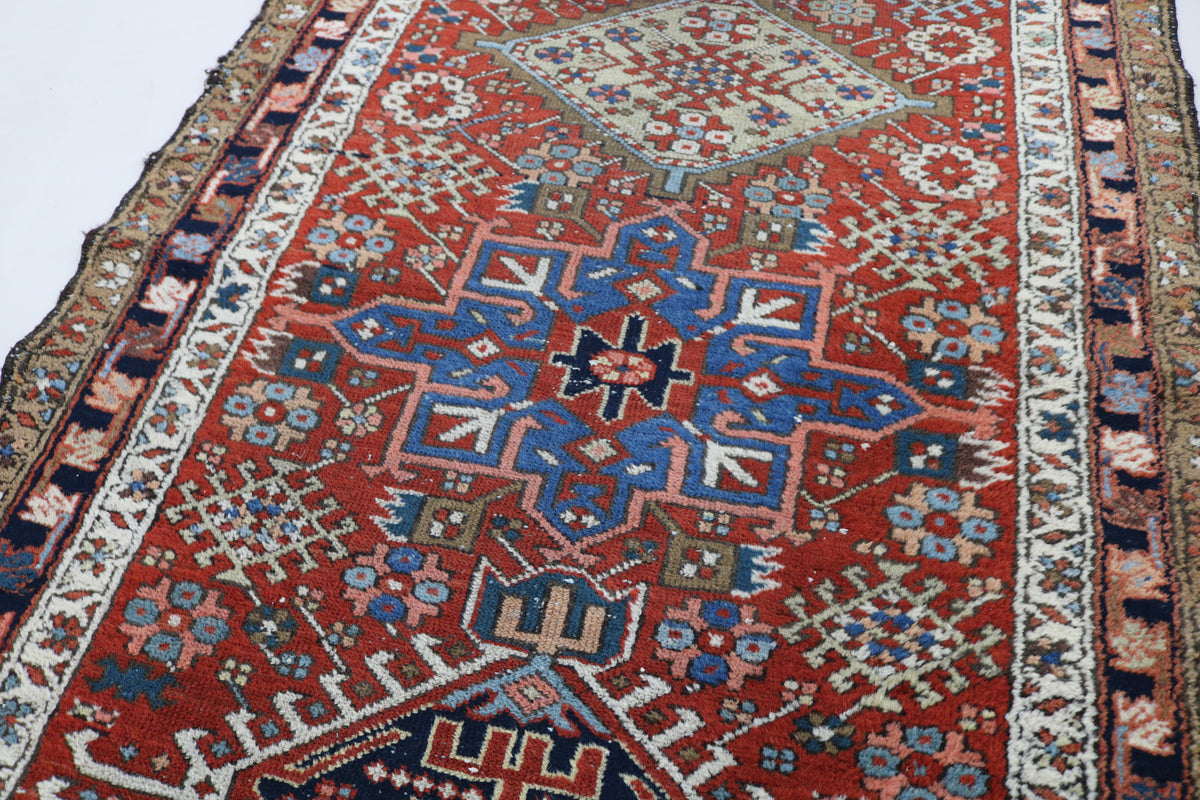 Close detail of geometric Karaja pattern with rust, blue and camel tones