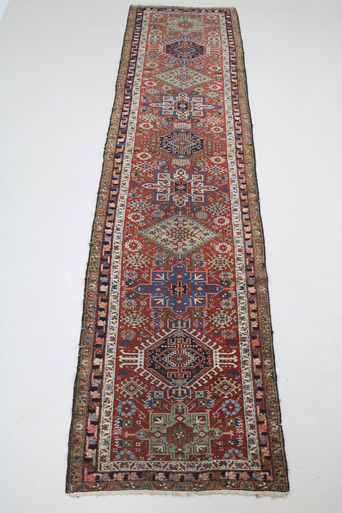 Full Persian Karaja runner showing elongated design with repeating geometric medallions