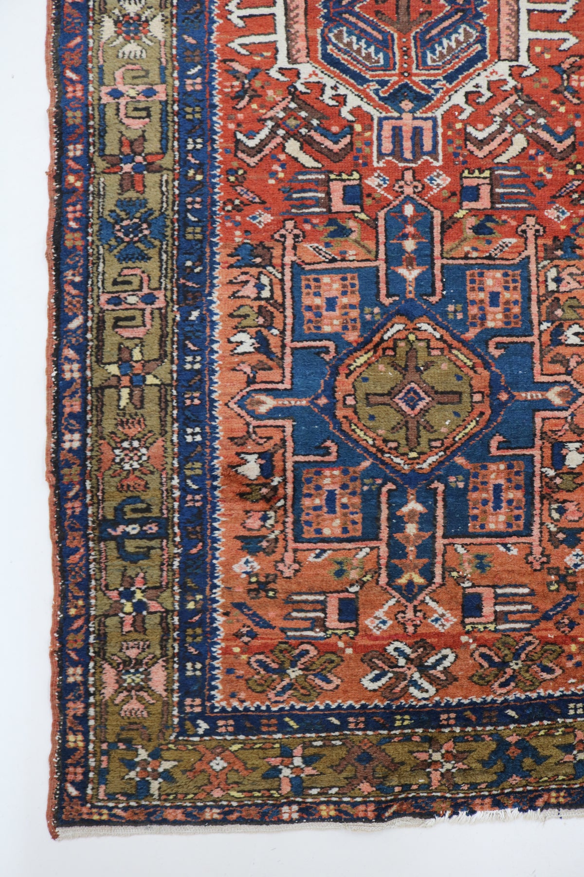 Antique Persian Karaja runner with rust red field, blue motifs and geometric medallions