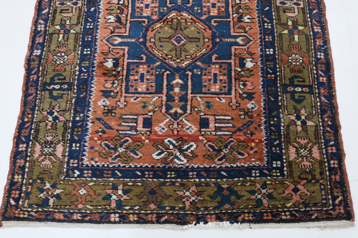 Karaja runner end featuring bold geometric motifs in rust red, blue and camel