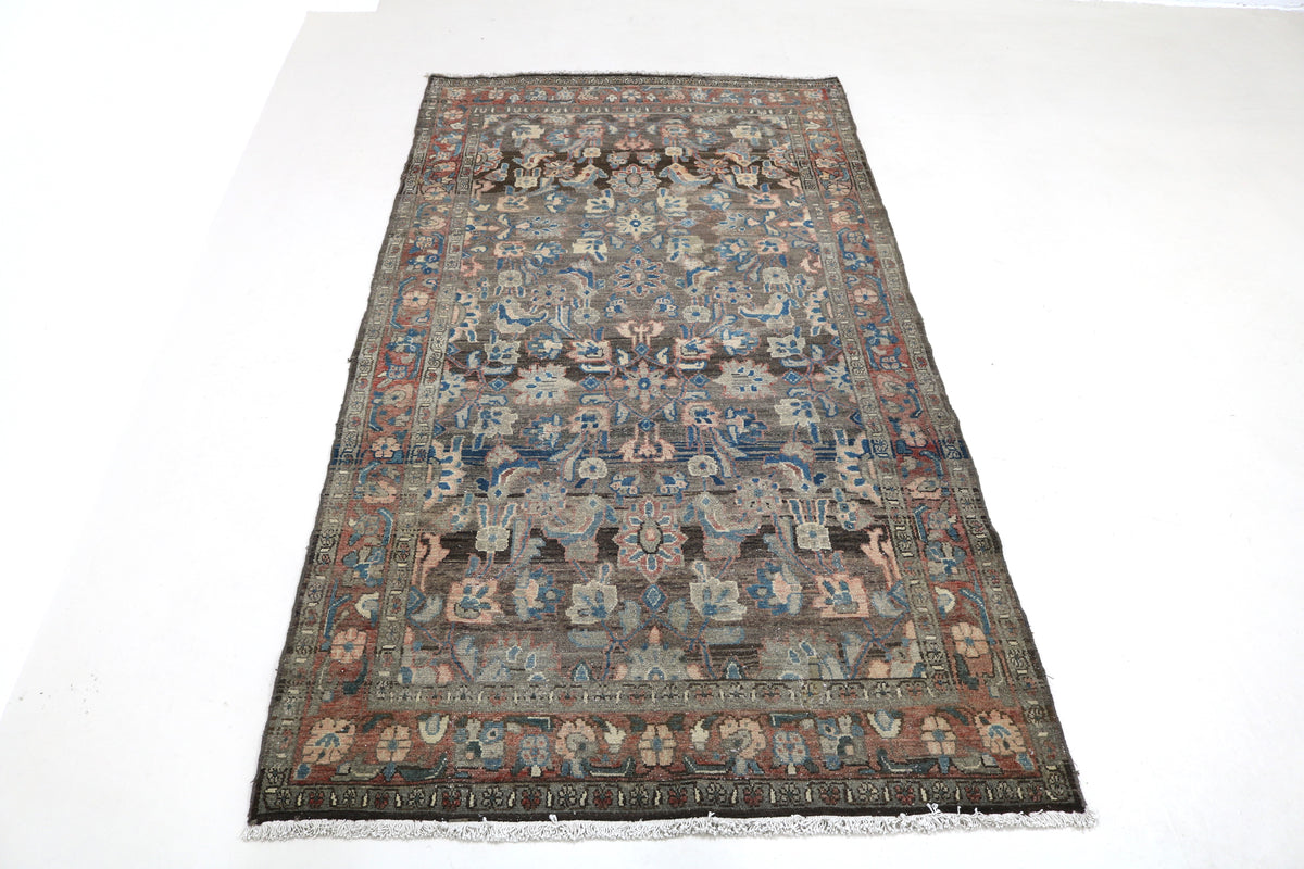 Full view of antique Malayer rug with repeating floral and geometric pattern