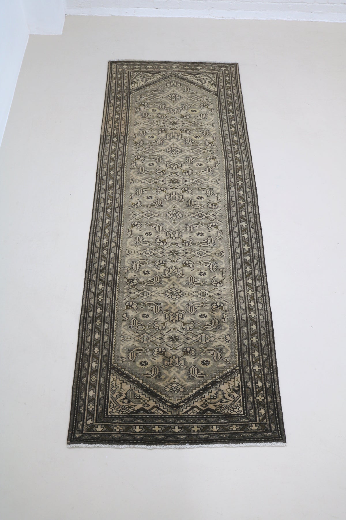 Full view of antique Malayer runner with repeating geometric pattern and long narrow format