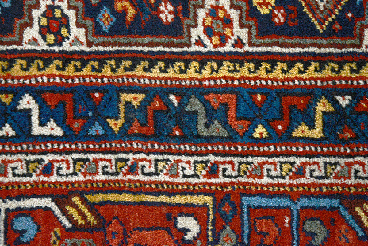 Detailed Qashqai carpet border featuring repeating geometric patterns and contrasting blue accents
