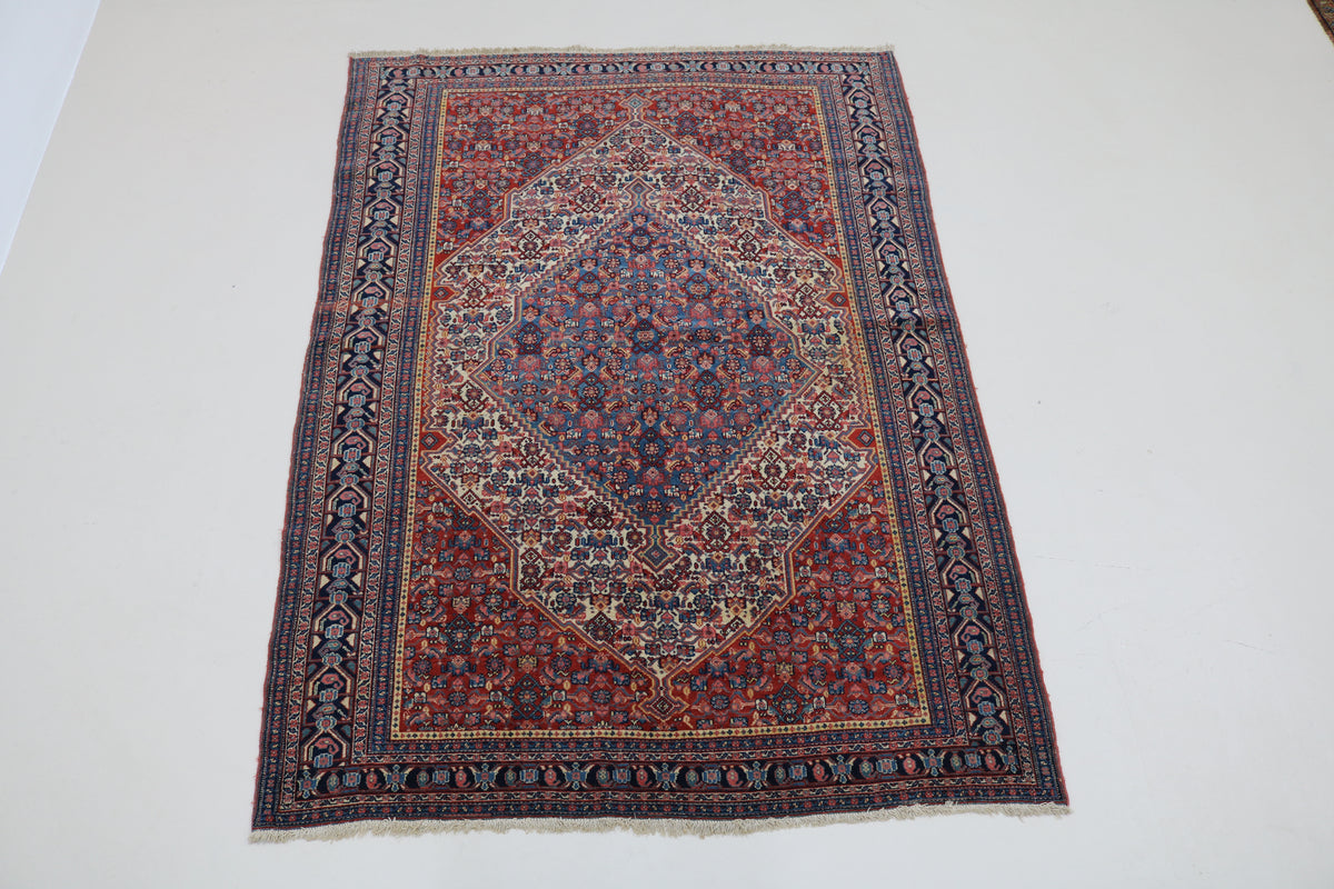 Full view of antique Senneh rug with intricate central medallion and densely patterned field