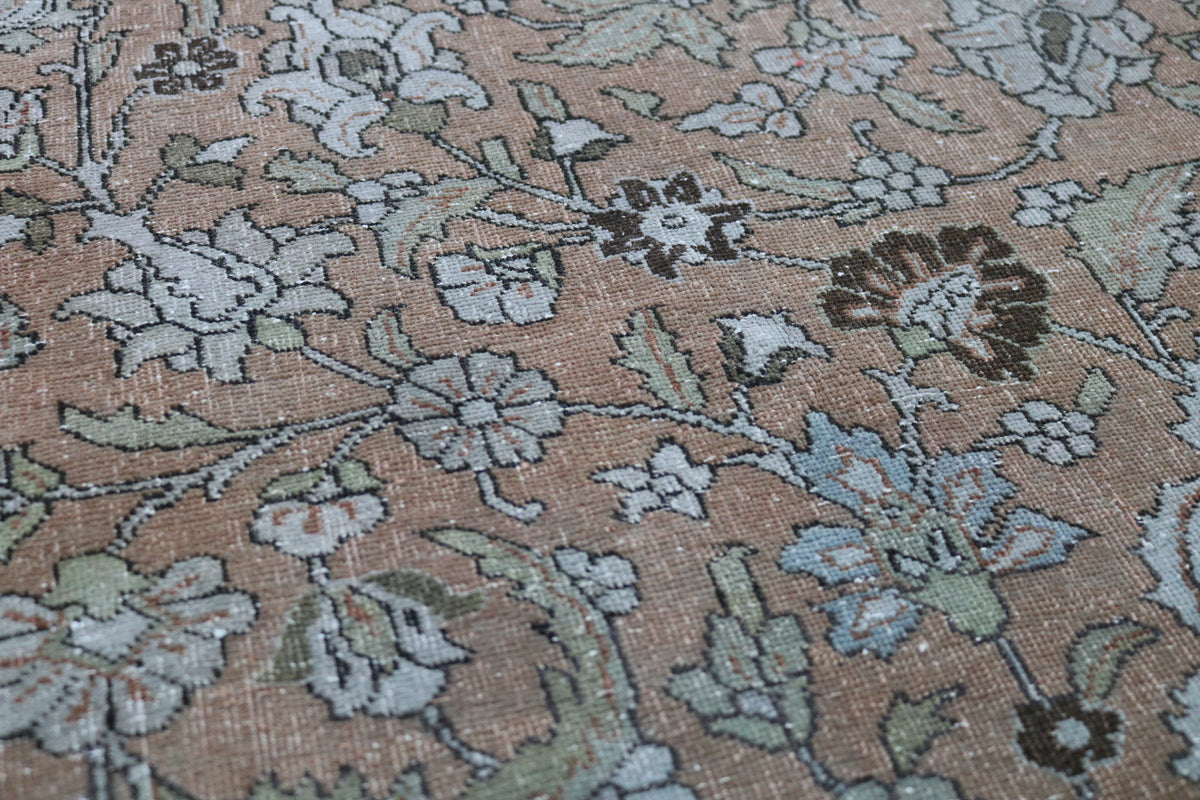 Detailed antique Tabriz carpet with intricate floral composition and decorative borders