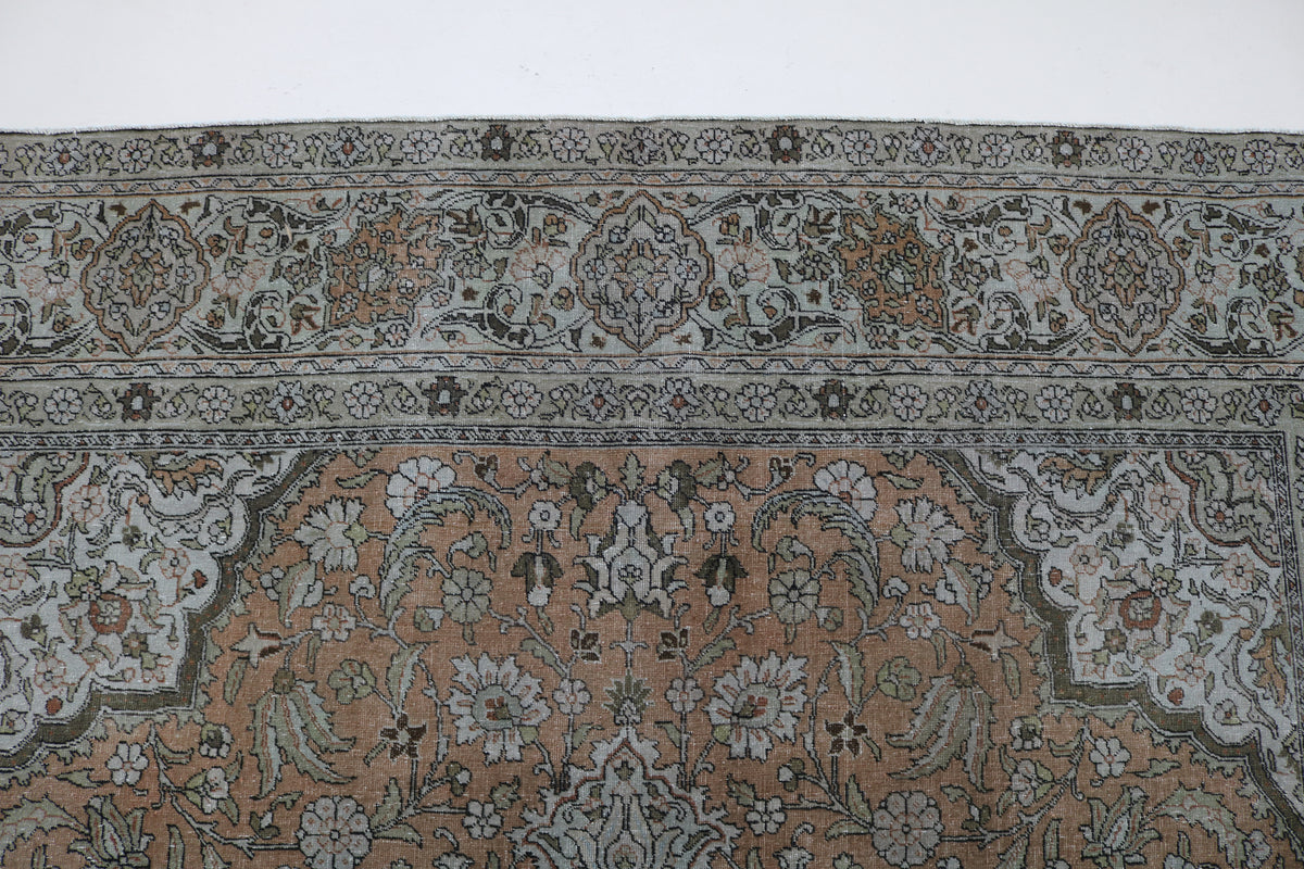 Close-up of Tabriz carpet border with intricate floral and geometric motifs