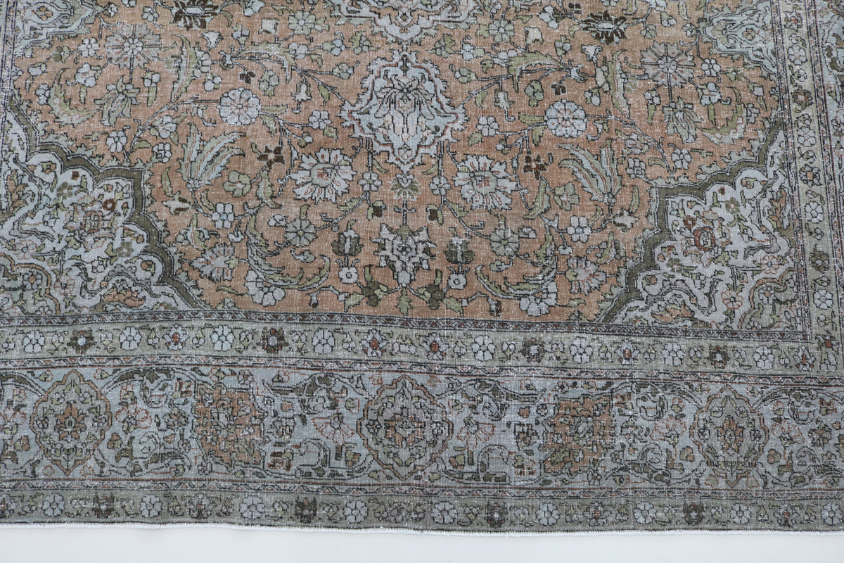 Detailed Tabriz carpet field with delicate floral patterns and muted colours