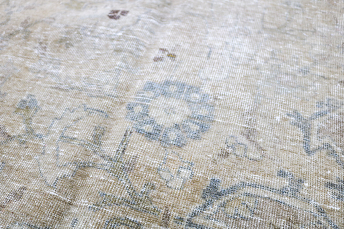 Close-up of Tabriz carpet showing subtle floral motifs and softly blended colours
