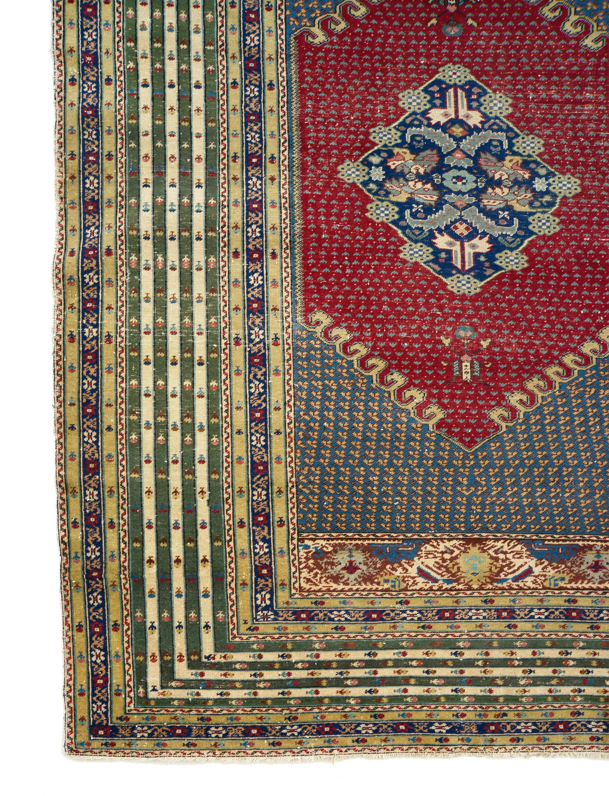 Antique Turkish rug with deep red field, blue medallion and layered geometric borders

