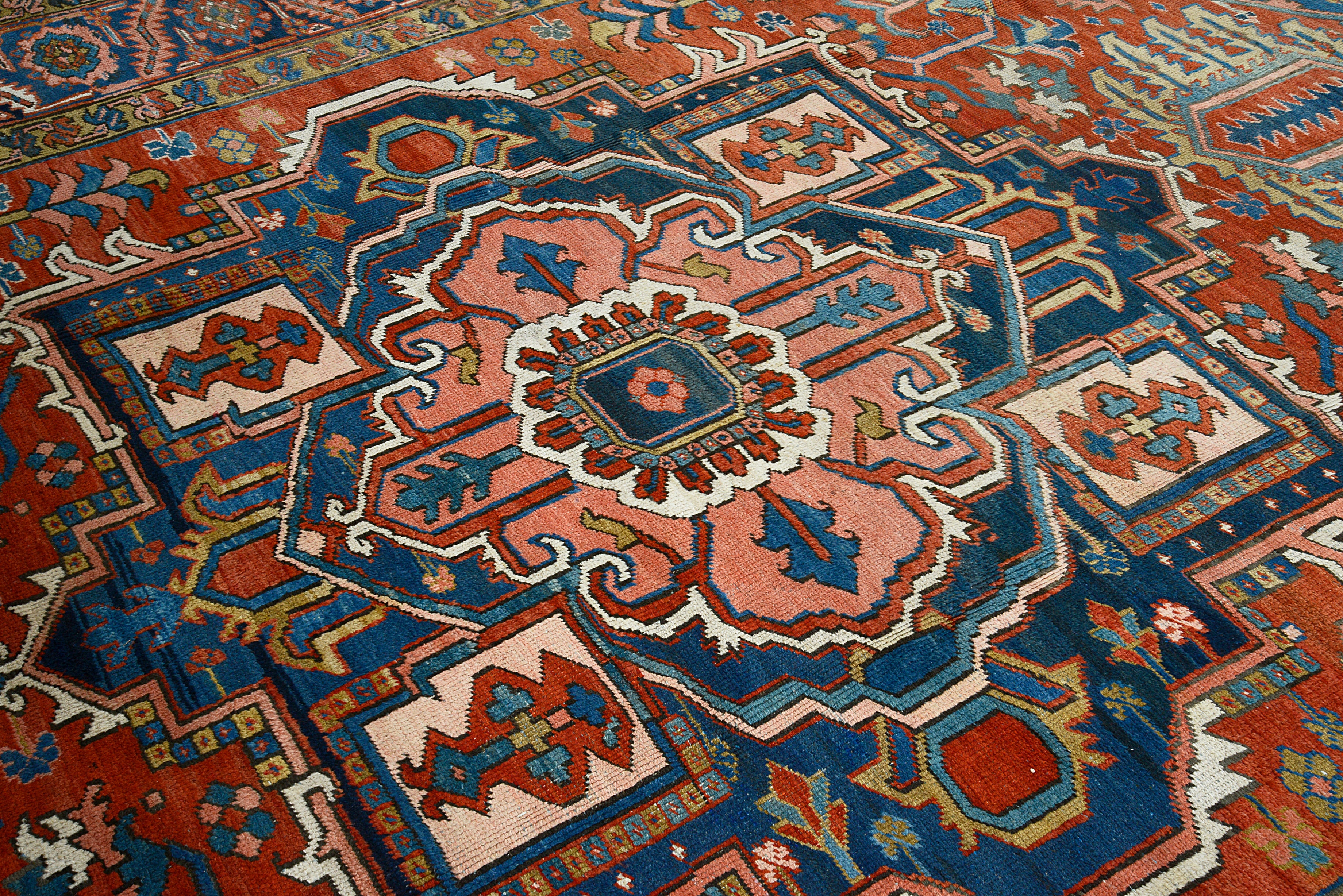 Close-up of central medallion
 geometric motifs on antique Persian Heriz carpet

