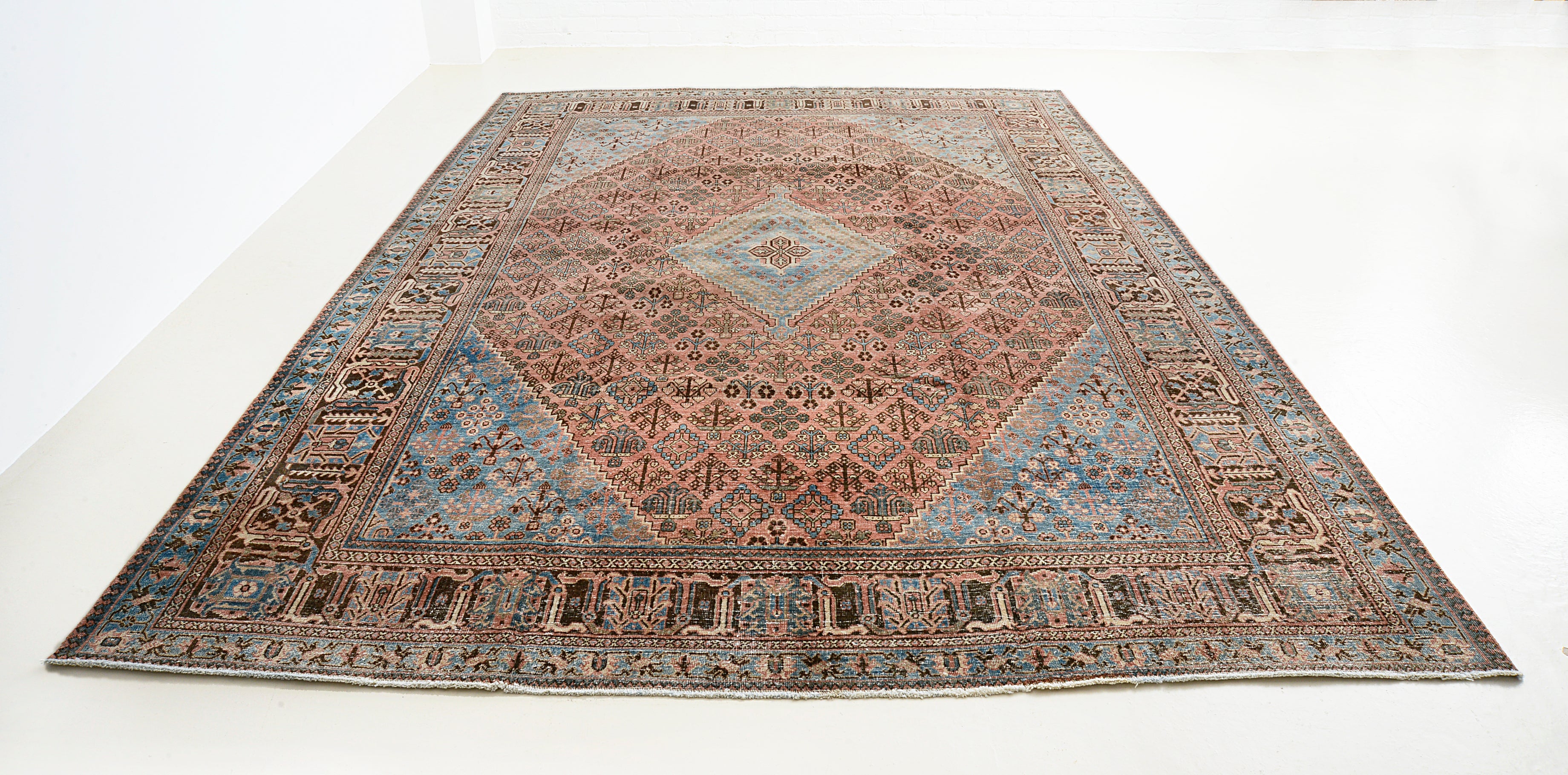 Full view of antique Persian Josheqan rug with lattice medallion design
