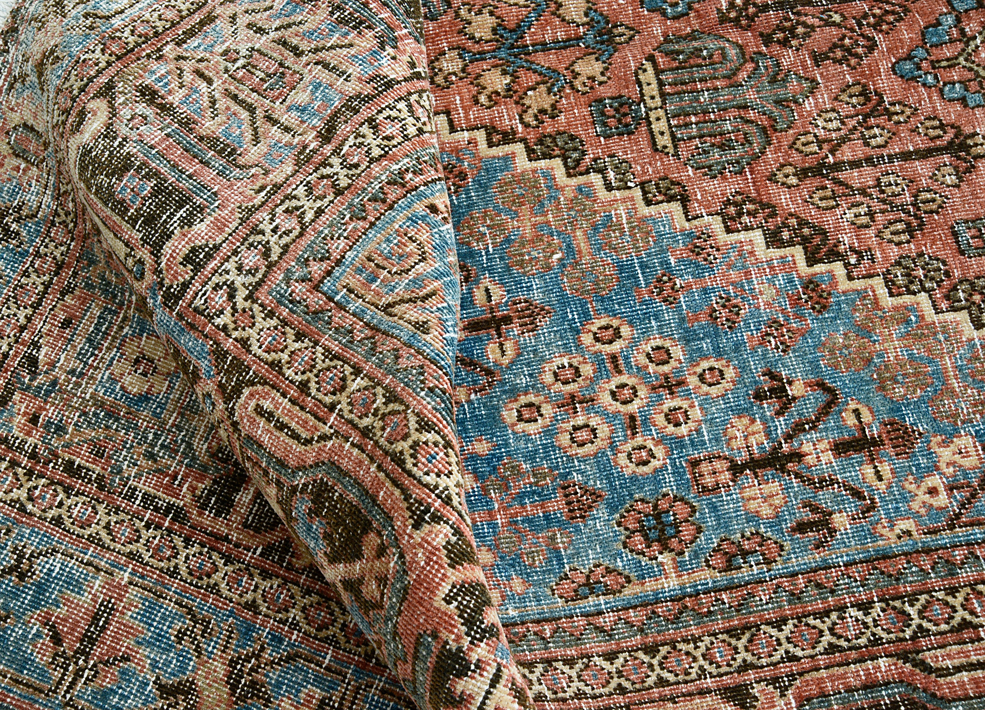Close-up of repeating geometric field motifs on Persian Josheqan rug
