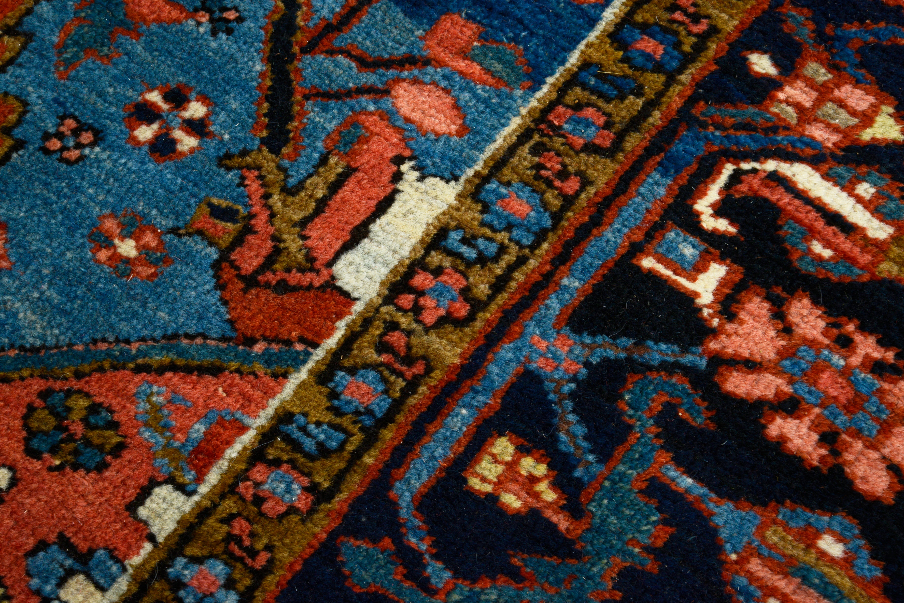 Close-up of hand-knotted wool texture on antique Persian Heriz carpet

