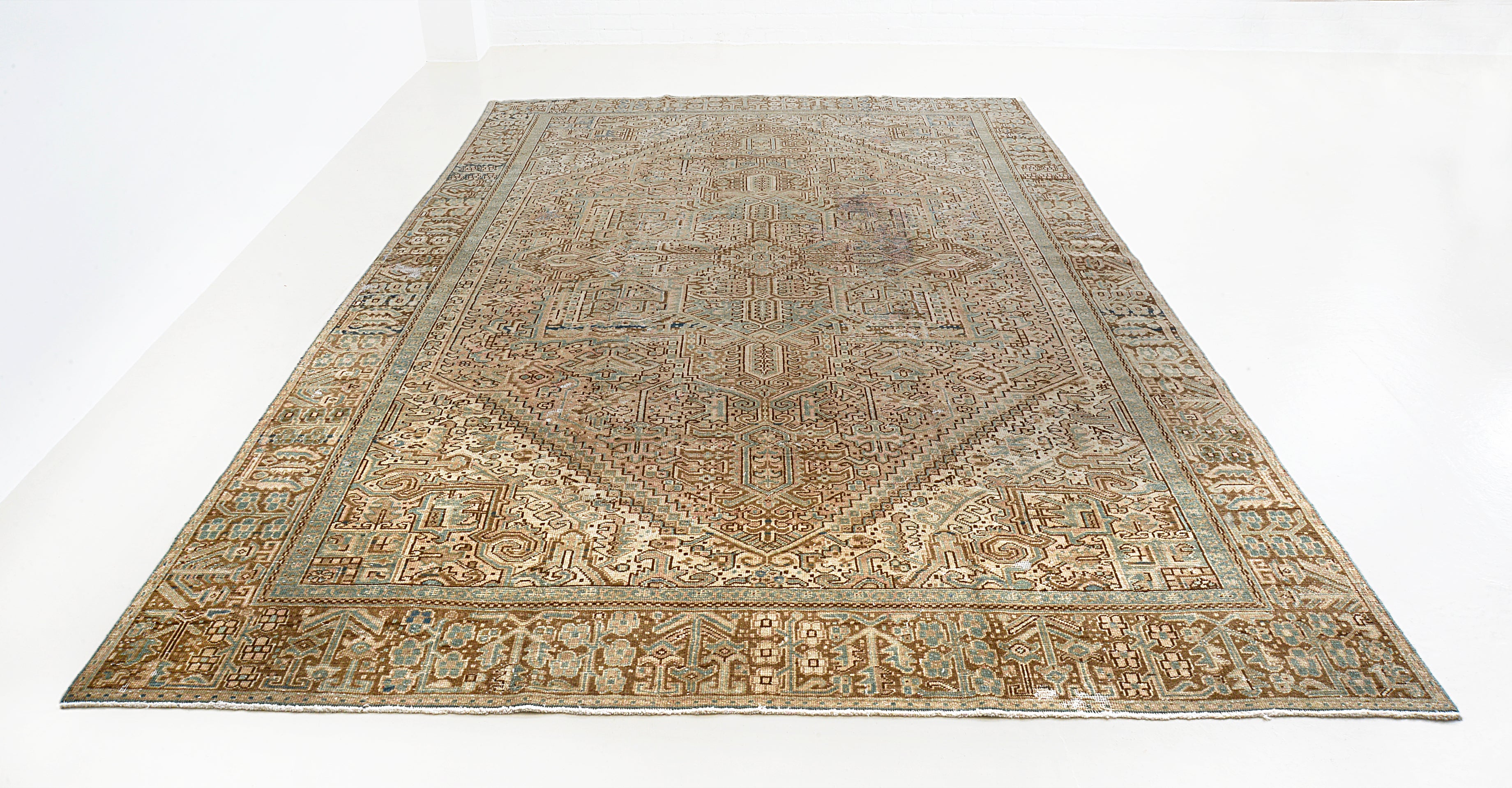 Full view of antique Persian Heriz carpet with traditional geometric design
