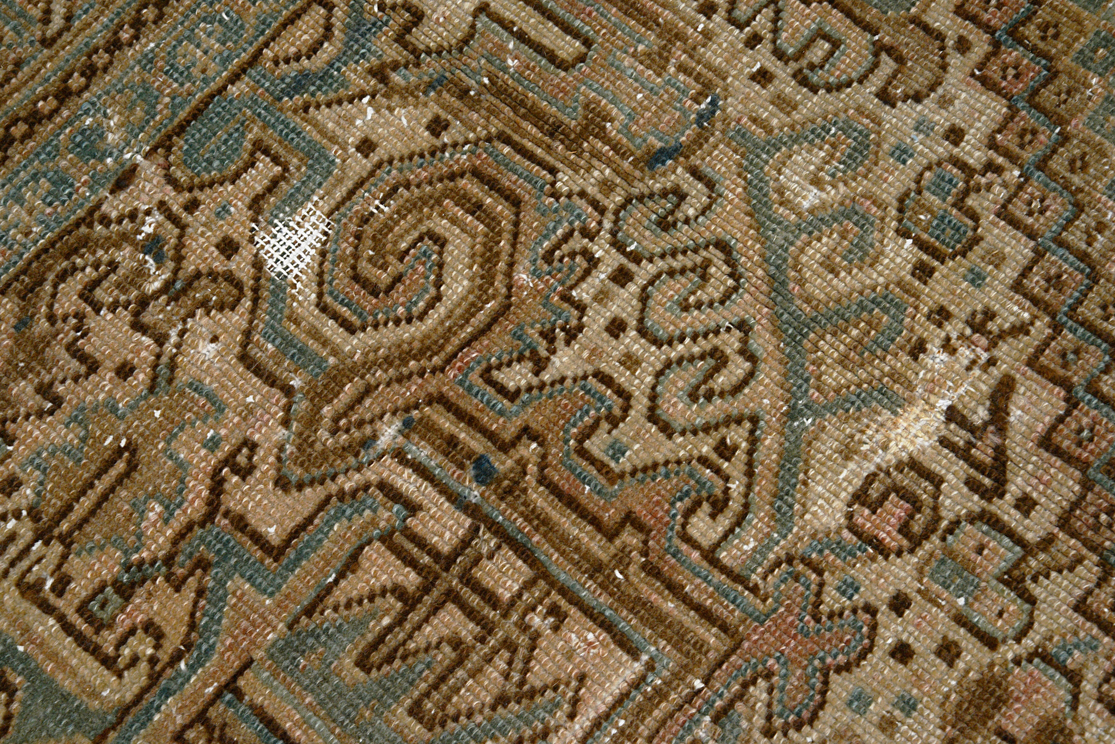 Close-up of texture on antique Persian Heriz carpet 
