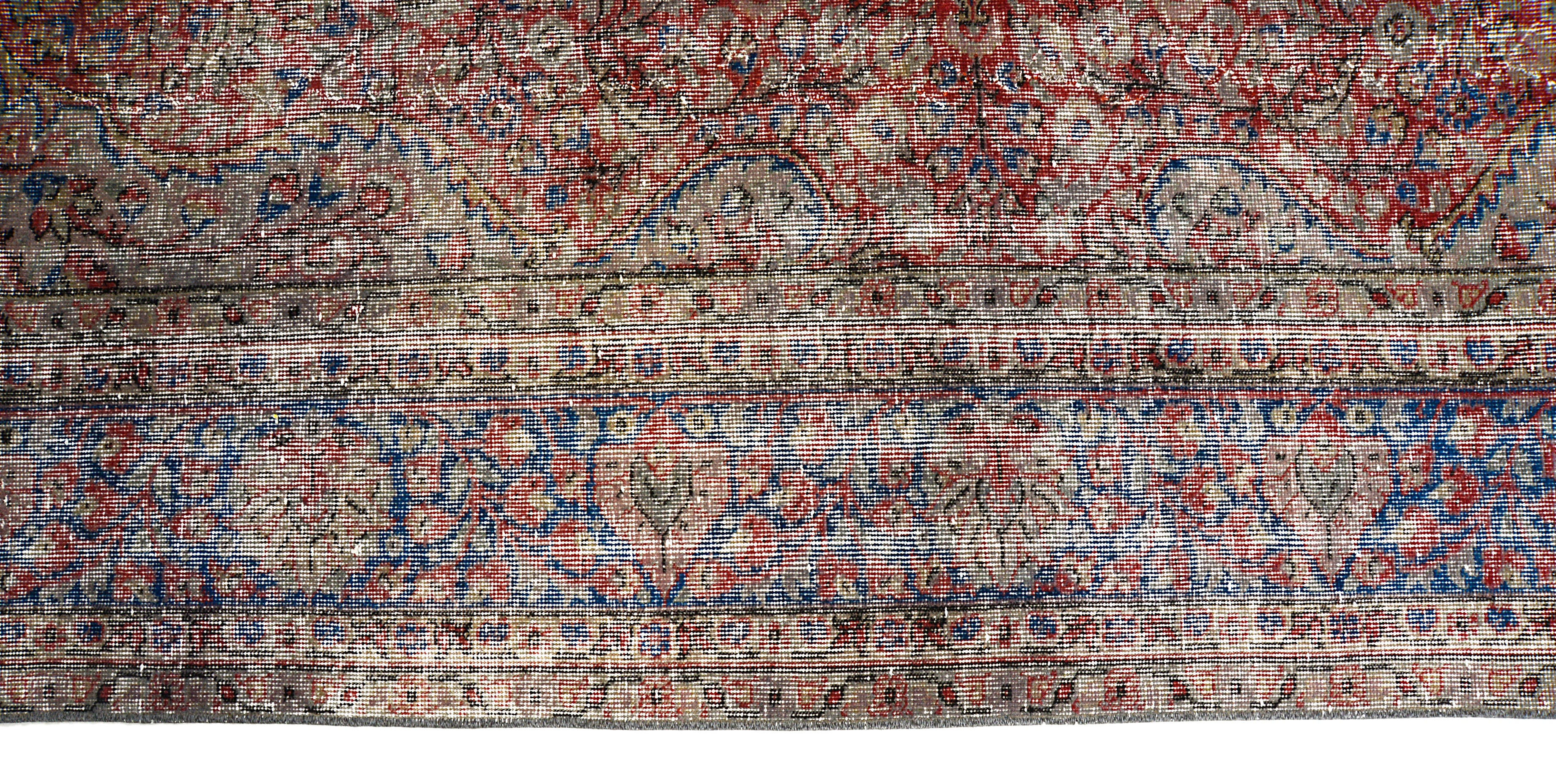 Close-up showing muted colors and patina on vintage Turkish carpet

