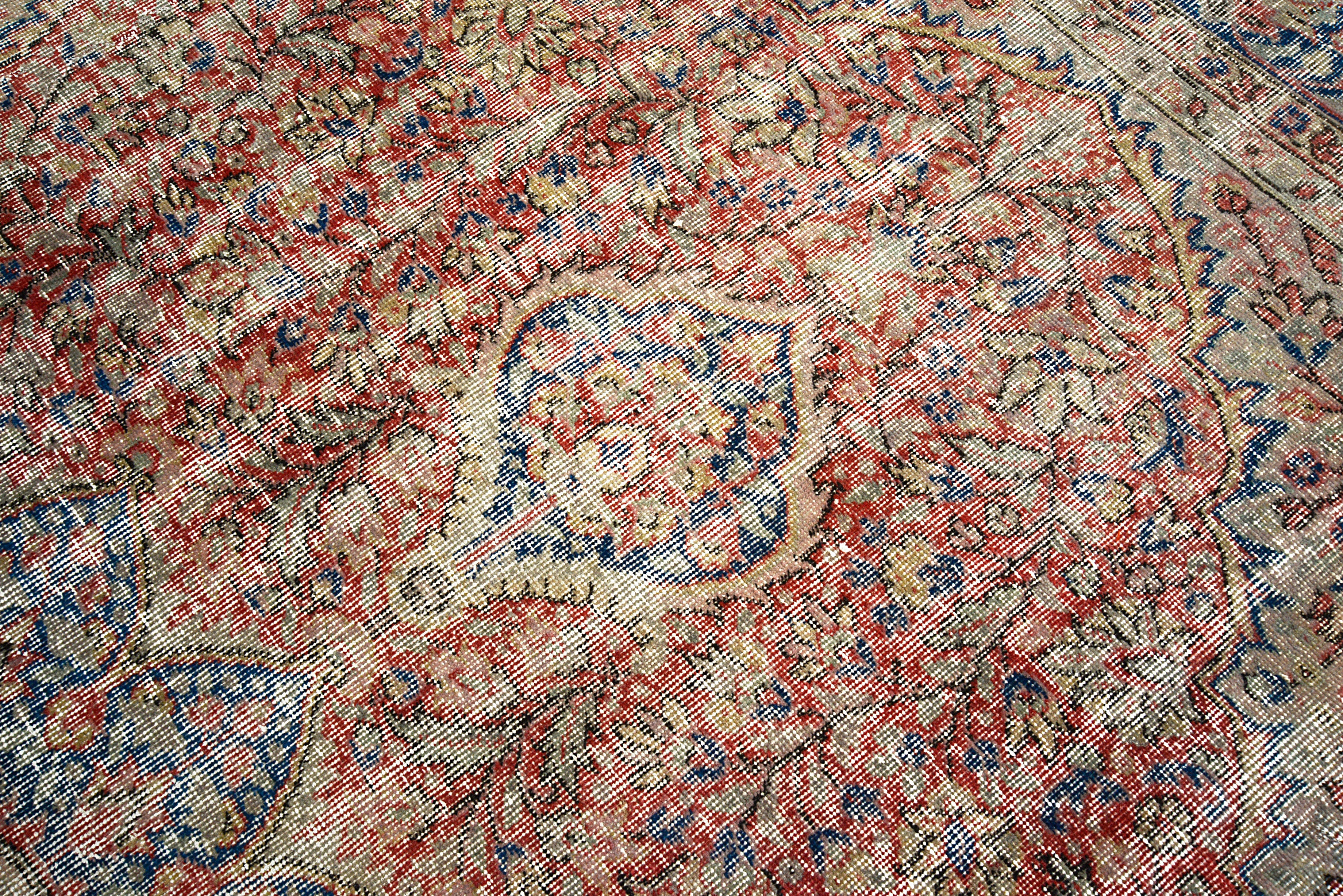 Close-up of geometric field motifs on vintage Turkish carpet
