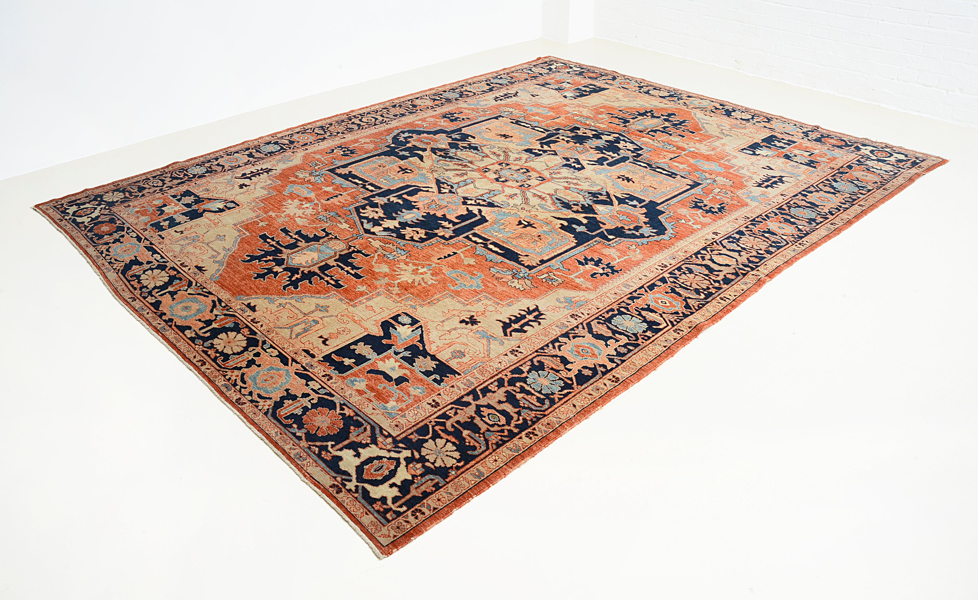 Perspective view of vintage Persian Heriz Serapi carpet on floor