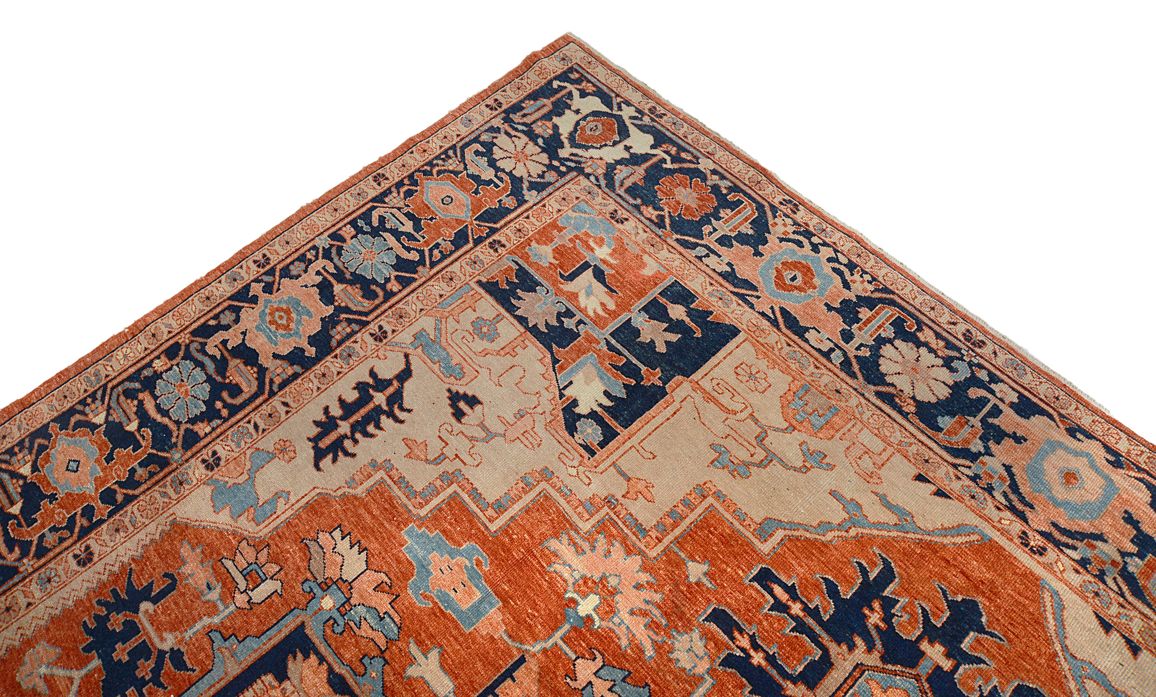 Perspective view the corner of vintage Persian Heriz Serapi carpet on the floor
