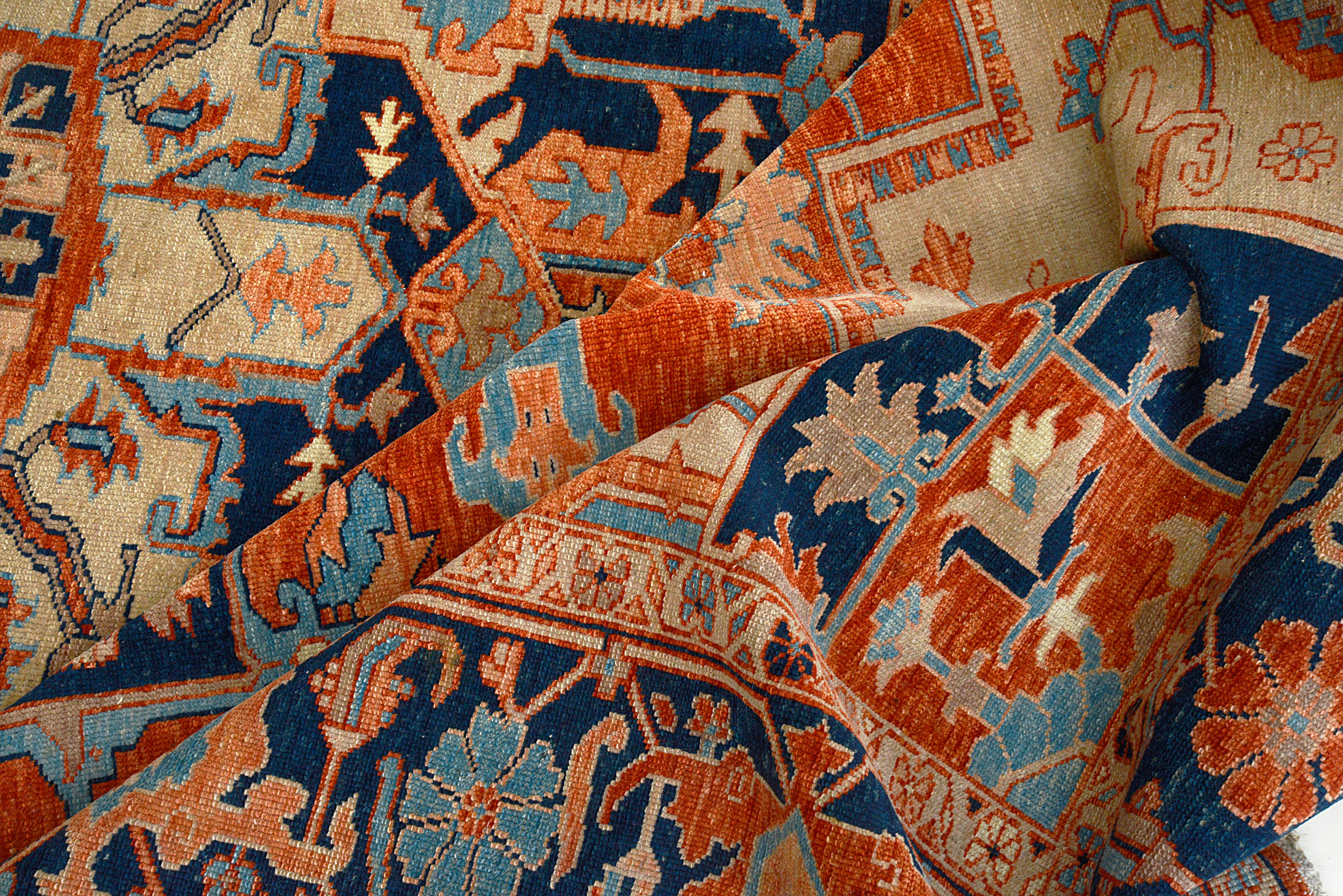 Close-up showing color variation and motifs on Persian Heriz Serapi carpet
