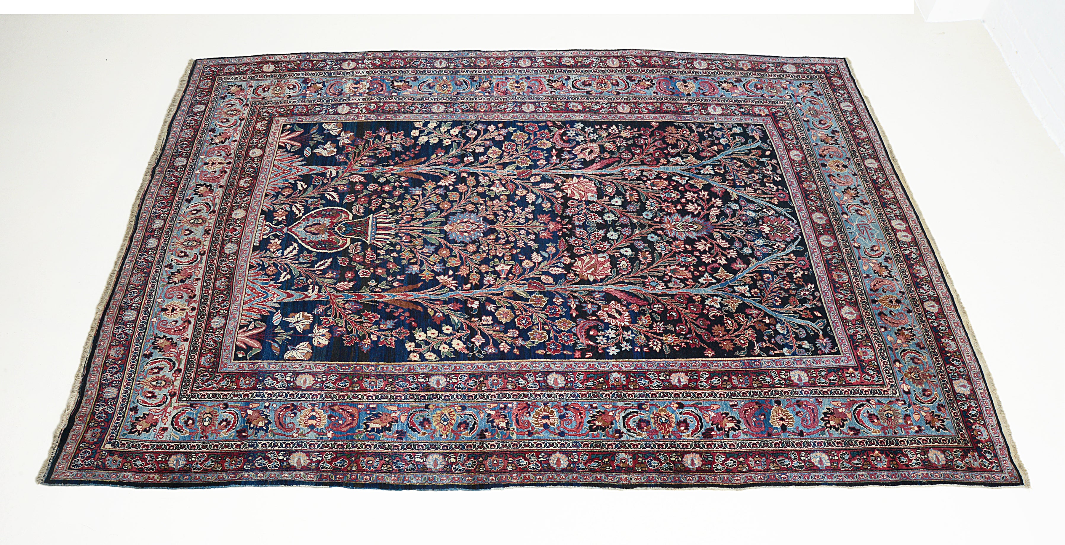 Secondary full view of an antique Persian Mashhad carpet showing balanced proportions and continuous pattern
