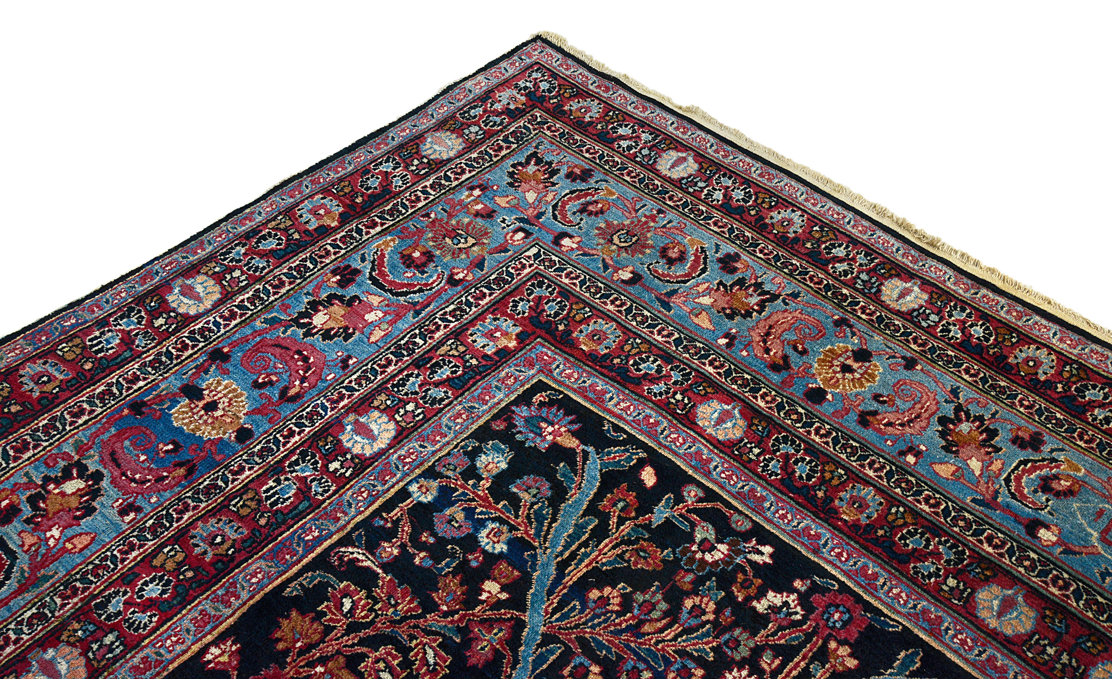 Close-up of the corner border design on an antique Persian Mashhad carpet
