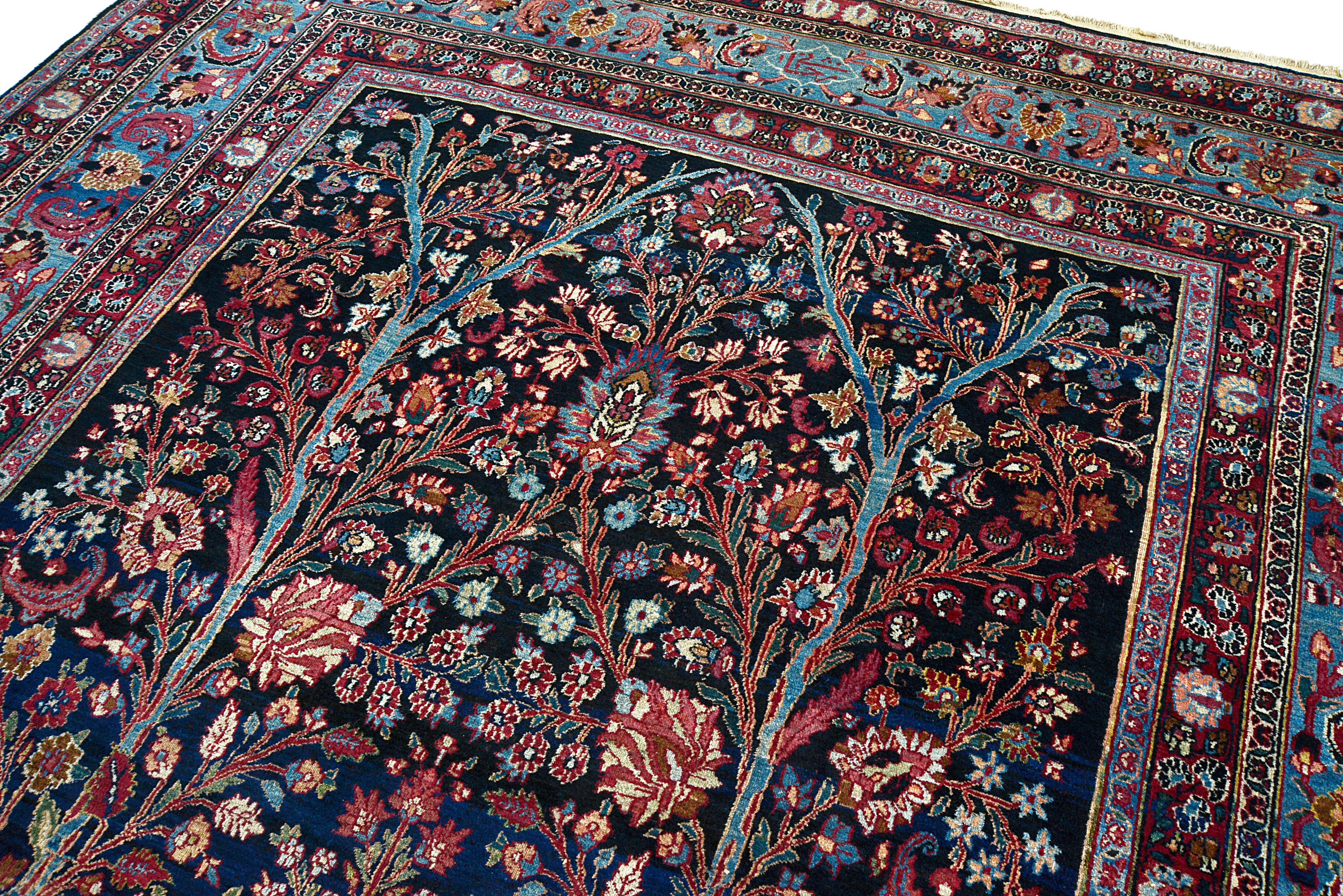 Close-up of floral drawing on an antique Persian Mashhad carpet
