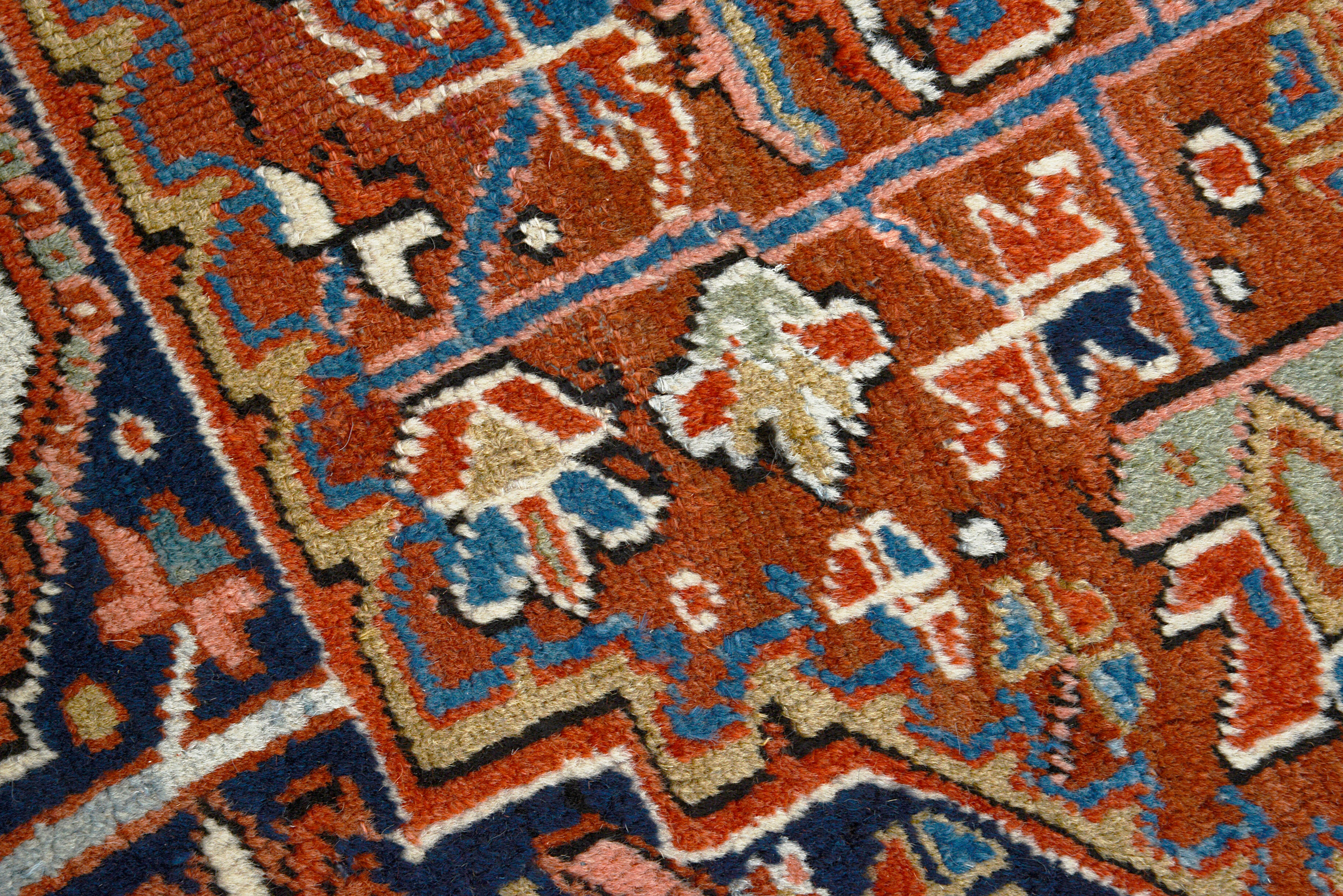Close-up of the geometric motif on an antique Persian Heriz carpet
