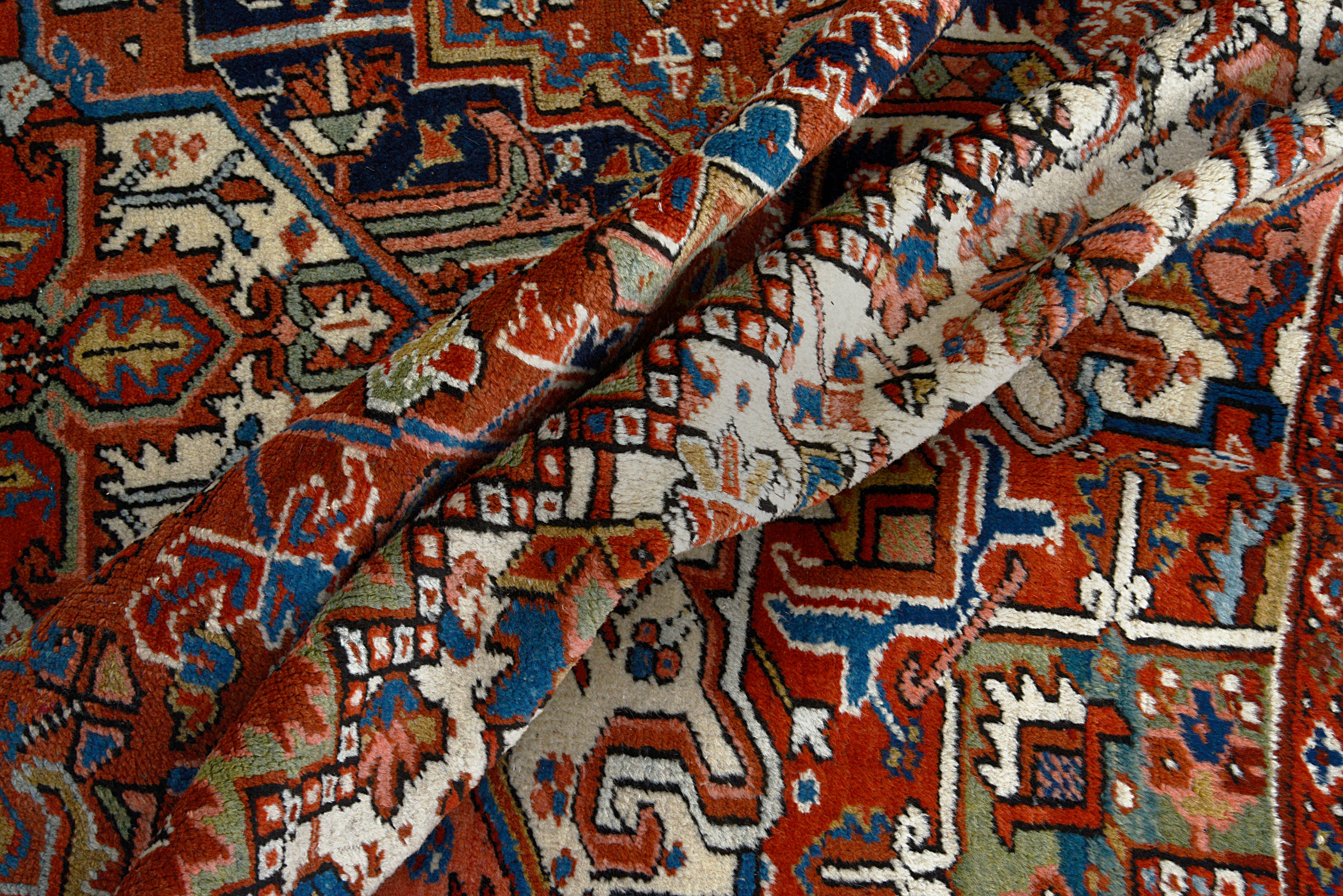 Hand-knotted wool texture of an antique Persian Heriz carpet
