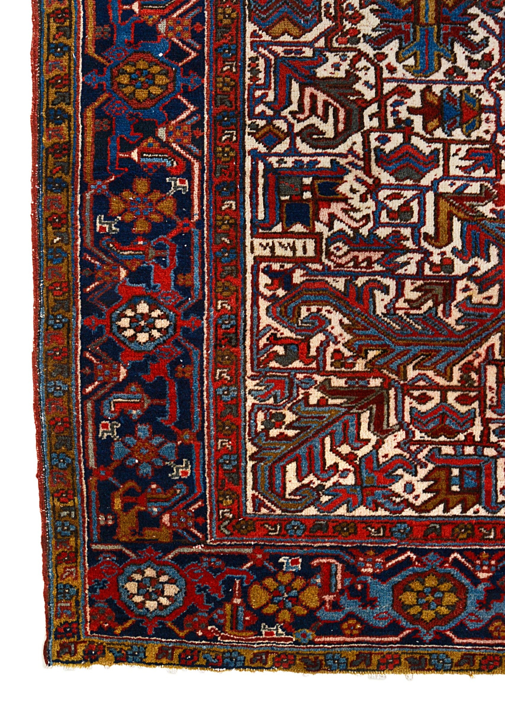 Vintage Heriz carpet corner detail showing hand-knotted wool and geometric border design
